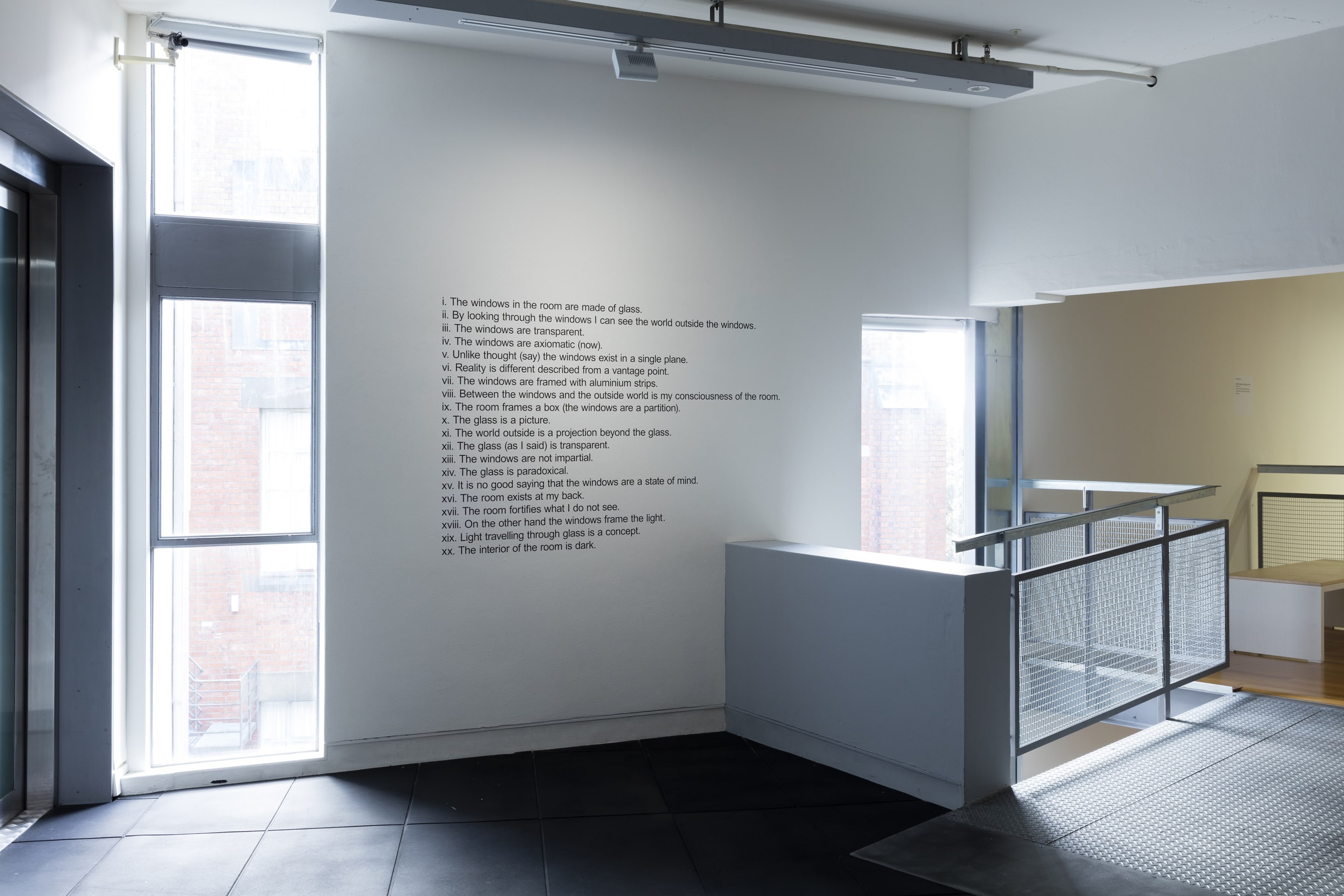 Installation view, Mike Parr, Facts about the Room, 1970/2016, vinyl lettering on wall, collection of Auckland Art Gallery Toi o Tamaki. In the exhibition Inhabiting Space at the Adam Art Gallery Te Pātaka Toi, Victoria University of Wellington (photo: Shaun Waugh)