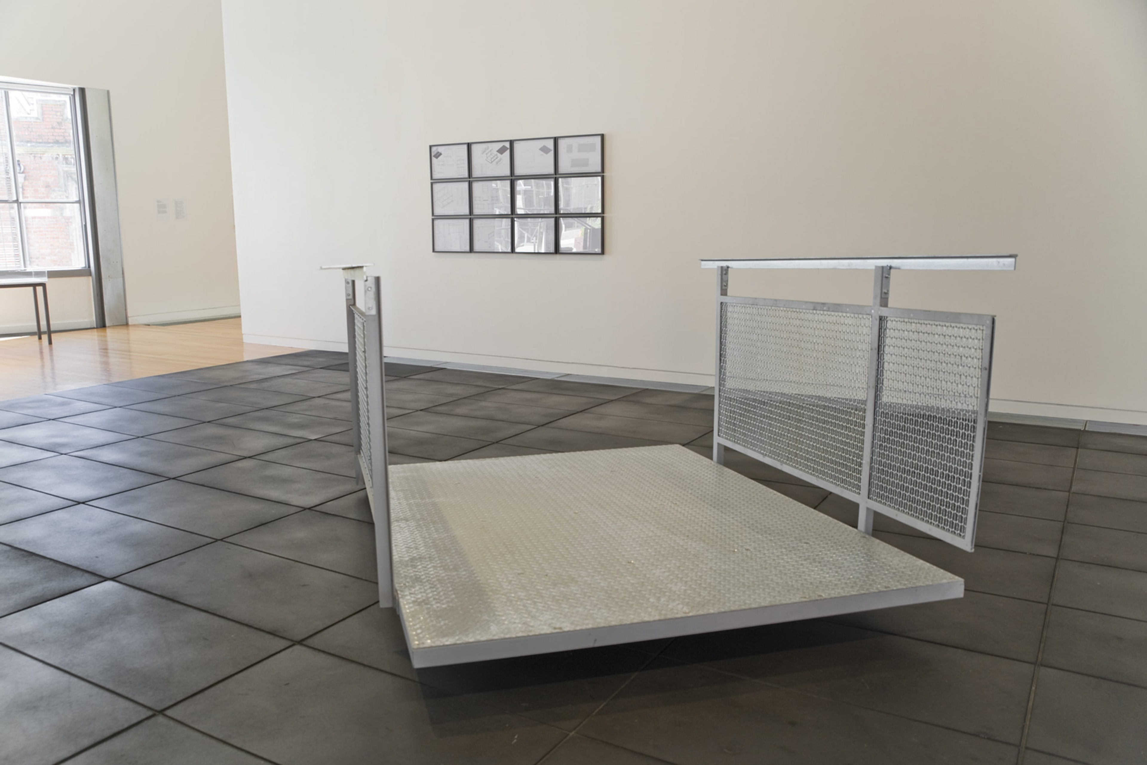 Eddie Clemens, Collector’s Edition Glitch (Viewing Bridge), 2014, 100 x 45 tapered flange beam (cut in half), mild metal, Metro105 woven mesh, tread plate (1 bar pattern), equal angle channel, adjustable swivel feet, counter-sunk socket and slot bolts, spray arc zinc, electroplated zinc, hot-dip galvanising, and 12 framed A3 CAD drawings, Victoria University of Wellington Art Collection, gift of the artist 2016. On view in the exhibition Out of Site – Works from the Victoria University of Wellington Art Collection, at Adam Art Gallery Te Pātaka Toi Victoria University of Wellington, 18 February – 23 April 2017, Photo: Shaun Matthews