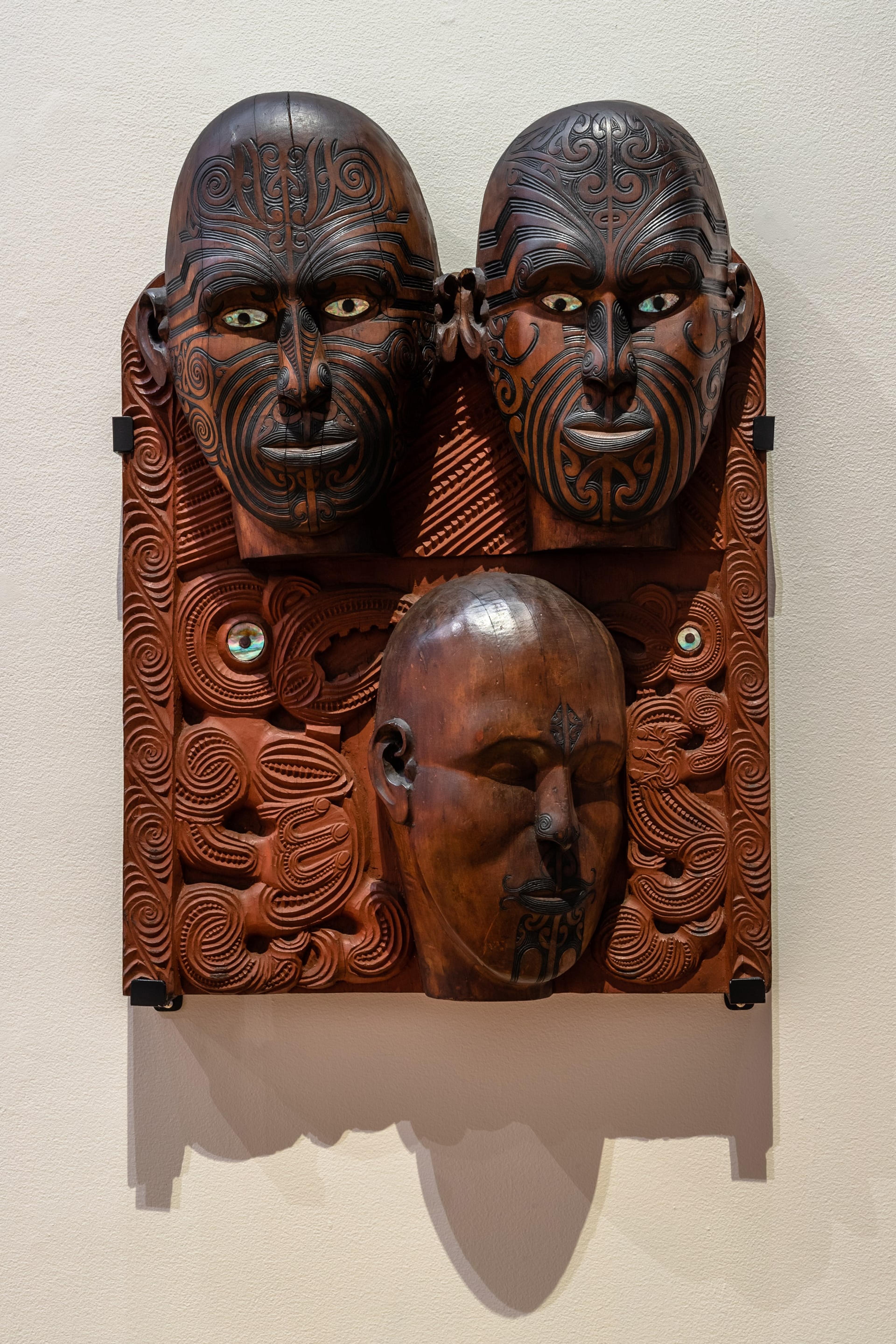 Tene Waitere (1853–1931, Ngāti Tarāwhai), Tā Moko Panel, 1896–99, wood, paint, 780 (h) × 560 (w) × 150 (d) mm, collection of Te Papa Tongarewa, Museum of New Zealand. Installation view, Tēnei Ao Tūroa – This Enduring World, Te Pātaka Toi Adam Art Gallery, Victoria University Wellington. Photo: Ted Whitaker