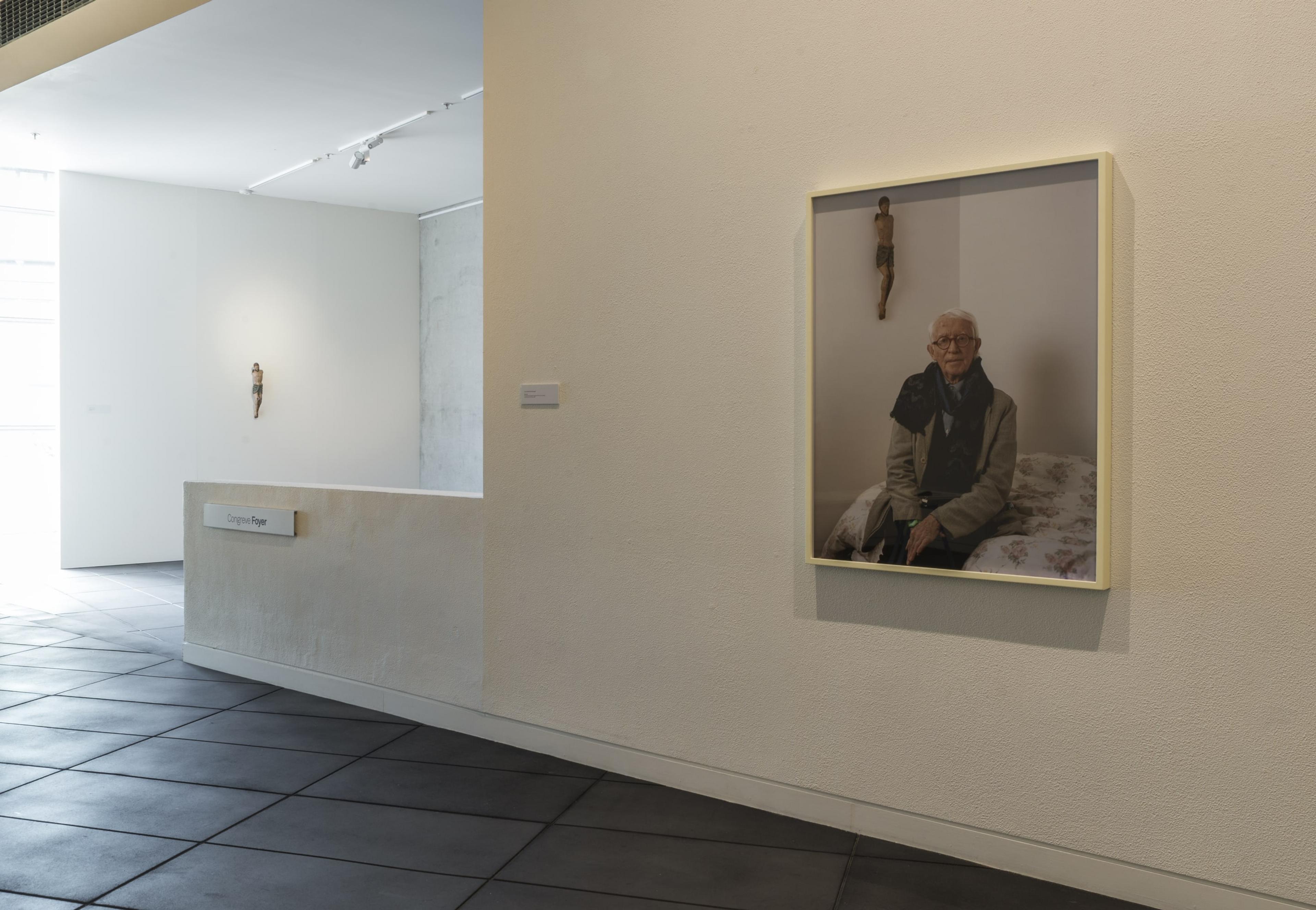 Installation view of Still looking: Peter McLeavey and the last photograph, 6 October – 20 December 2018, Adam Art Gallery Te Pātaka Toi. Foreground: Yvonne Todd, Peter, 2014, chromogenic photograph, commissioned from the artist in 2014, Collection of Peter McLeavey.