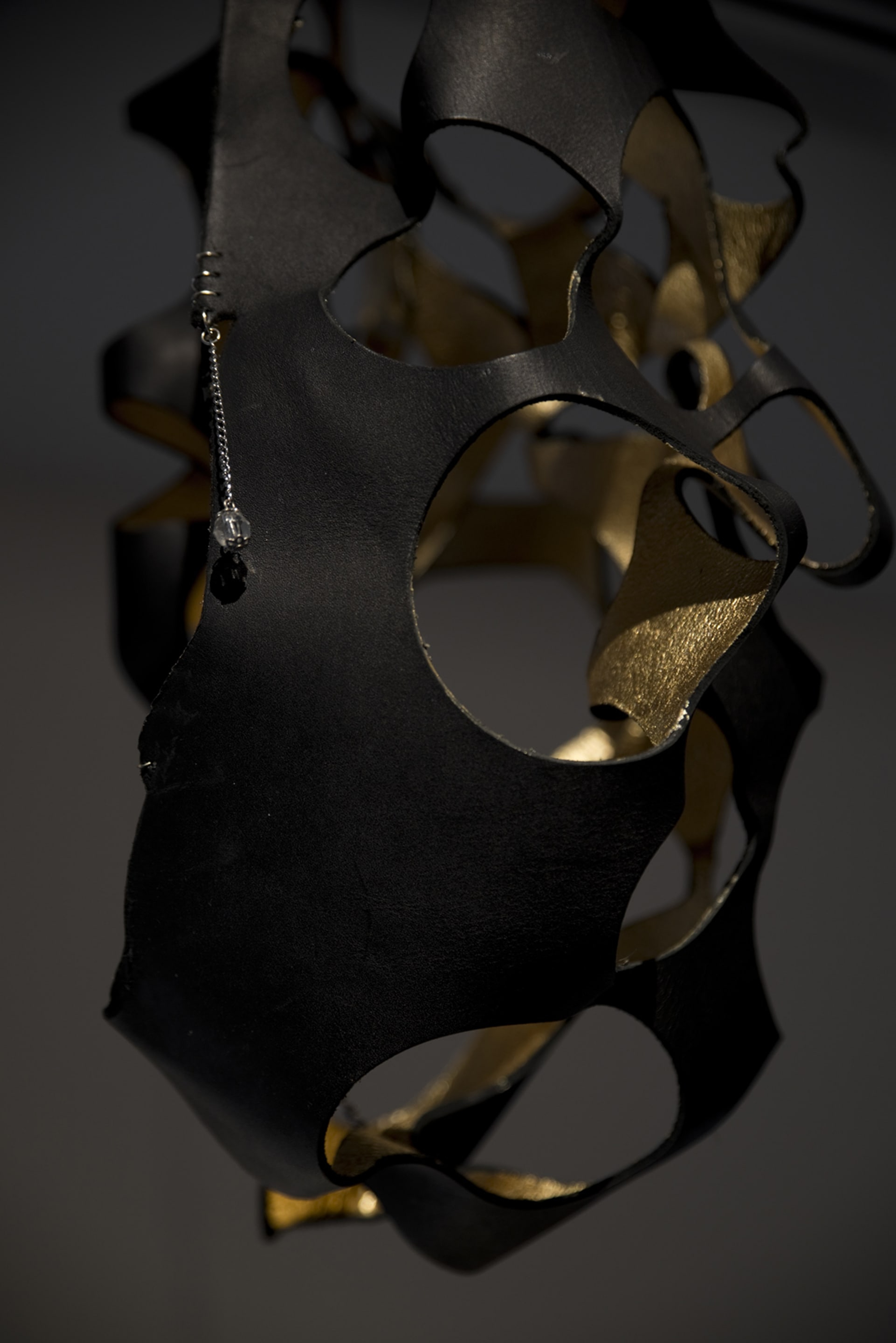 Signe Rose, Bondage Egg (detail), 2015, gold leaf, leather, chain, jewellery findings. Courtesy of the artist, on view in Acting Out at Adam Art Gallery Te Pātaka Toi, photo: Shaun Matthews