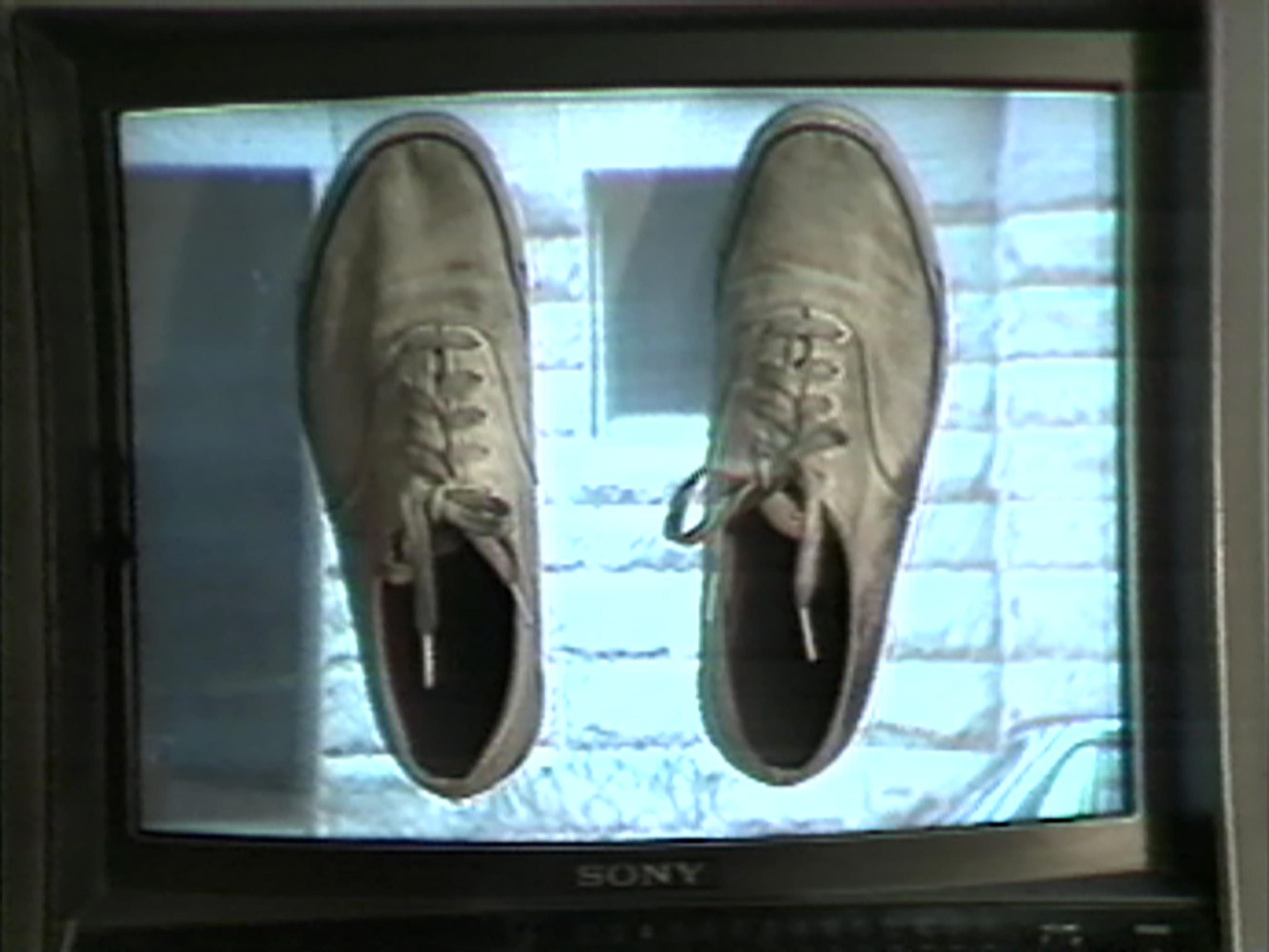 Still from Video walk showing pair of old sneakers