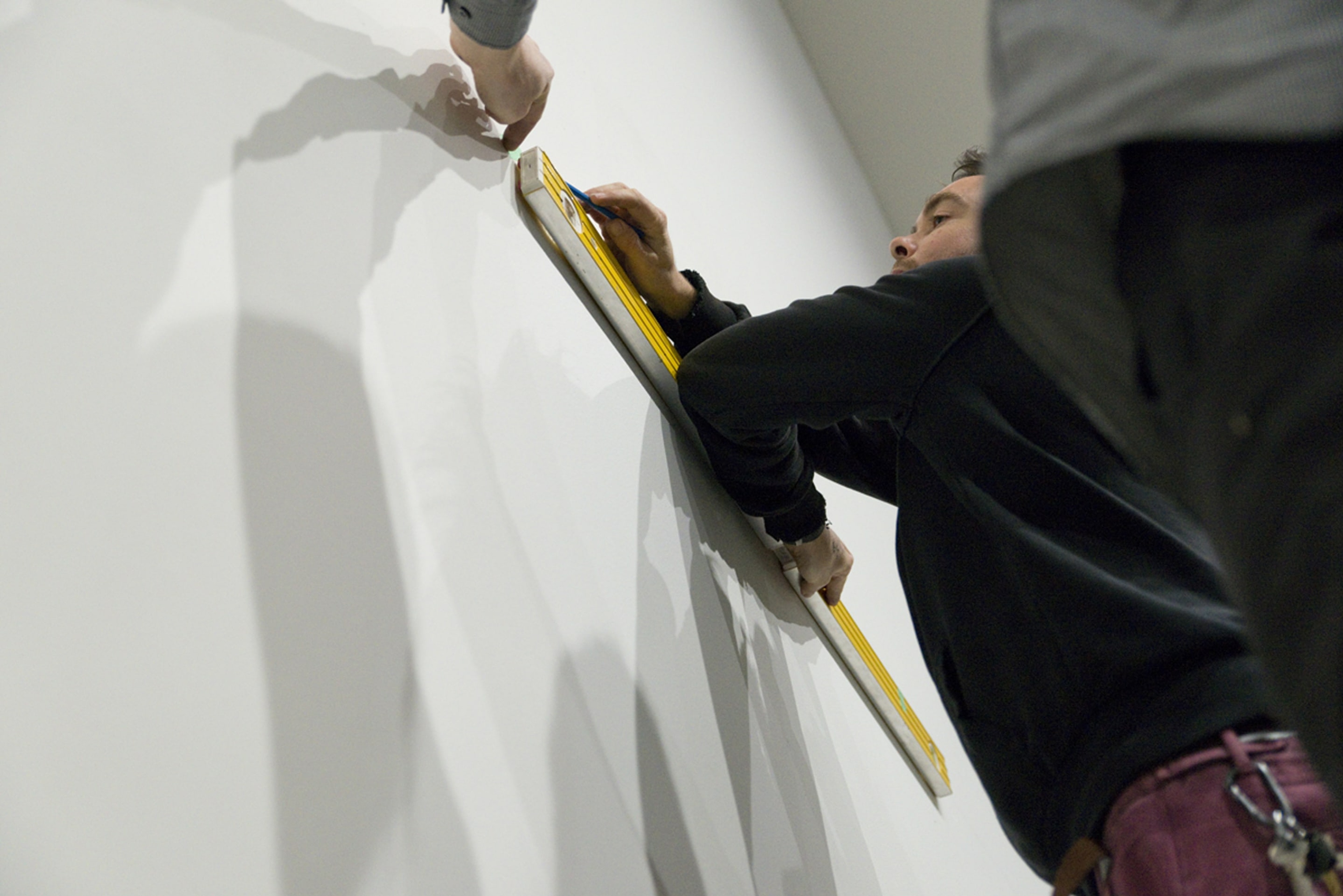 Installation of Julian Dashper Untitled (Black: for Fred Sandback, 2001–08) 2016, editions #2–10, black coloured pencil on wall, and Untitled (Blue: for Fred Sandback, 2001–08) 2016, editions #2–10, blue coloured pencil on wall. Courtesy of the Estate of Julian Daspher and Michael Lett, Auckland. Photographed during exhibition opening for Inhabiting Space at Adam Art Gallery Te Pātaka Toi, Victoria University of Wellington 13/05/16. (photo: Shaun Matthews)