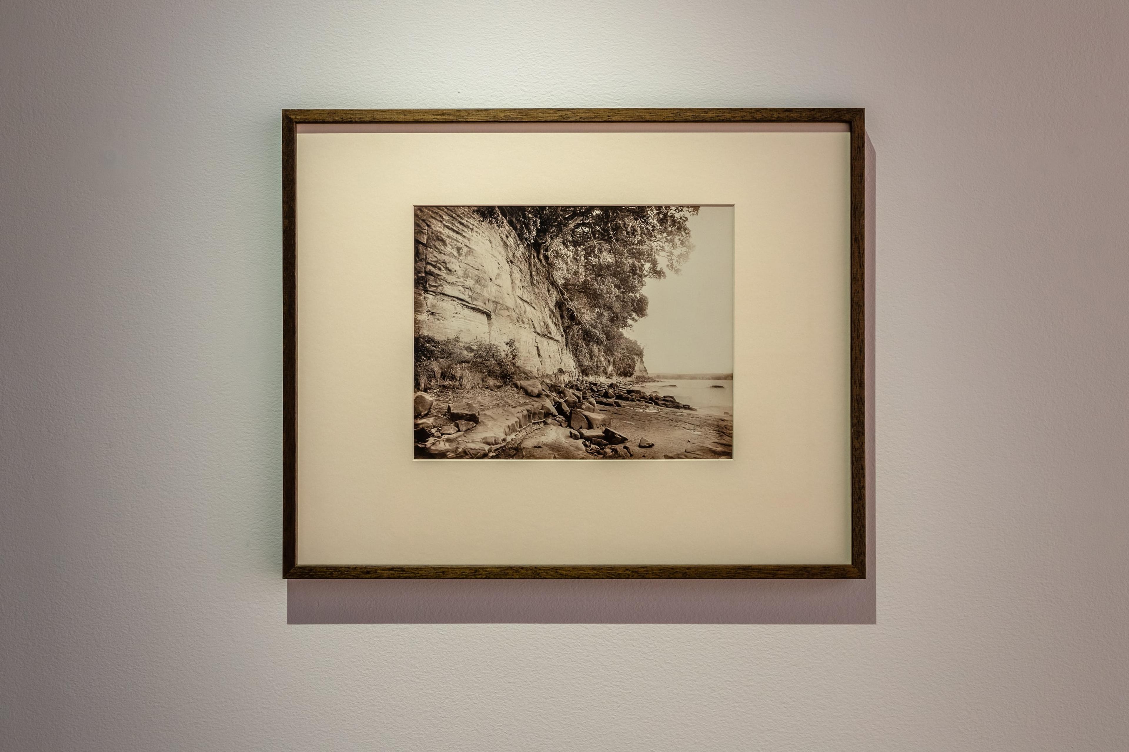 John Kinder (1819–1903), Cliffs, Whangaparaoa, near Auckland, 1868, albumen print, P1922-001-053, 235 × 315 mm, Hocken Collections Uare Taoka o Hākena, University of Otago. Installation view, Tēnei Ao Tūroa – This Enduring World, Te Pātaka Toi Adam Art Gallery, Victoria University Wellington. Photo: Ted Whitaker