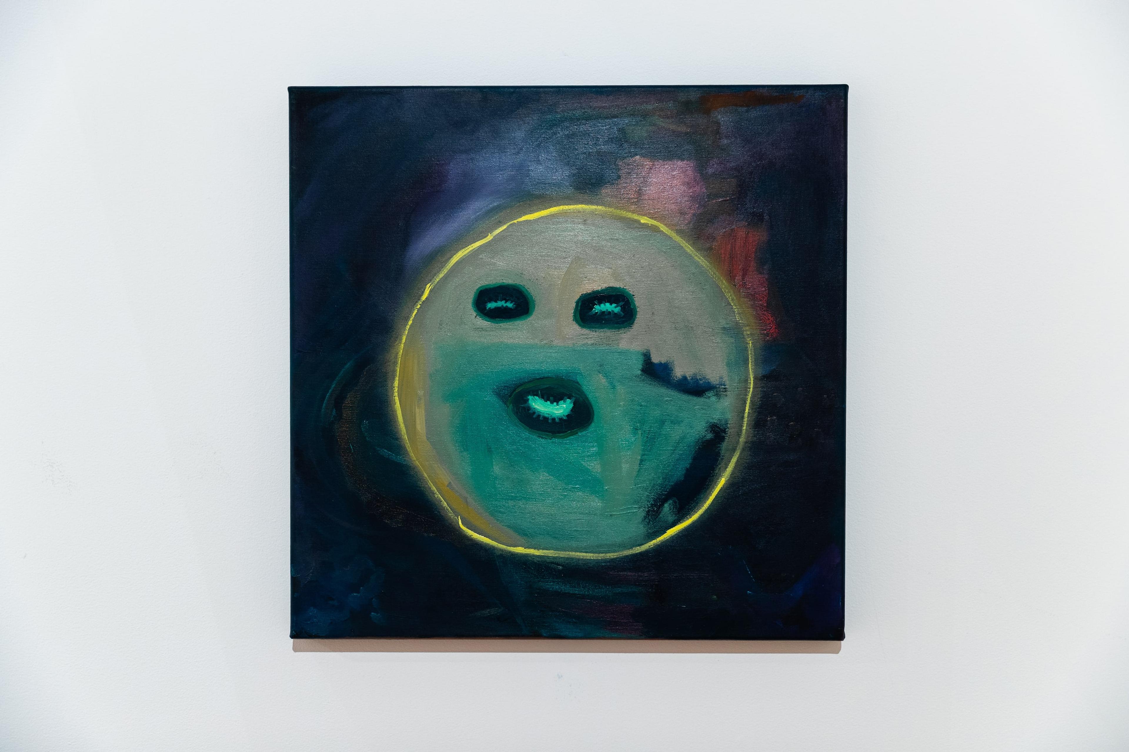 a square painting with dark smudgey colours and a yellow outline of a circe and joyful turquoise eyes and mouth, mounted on a white wall
