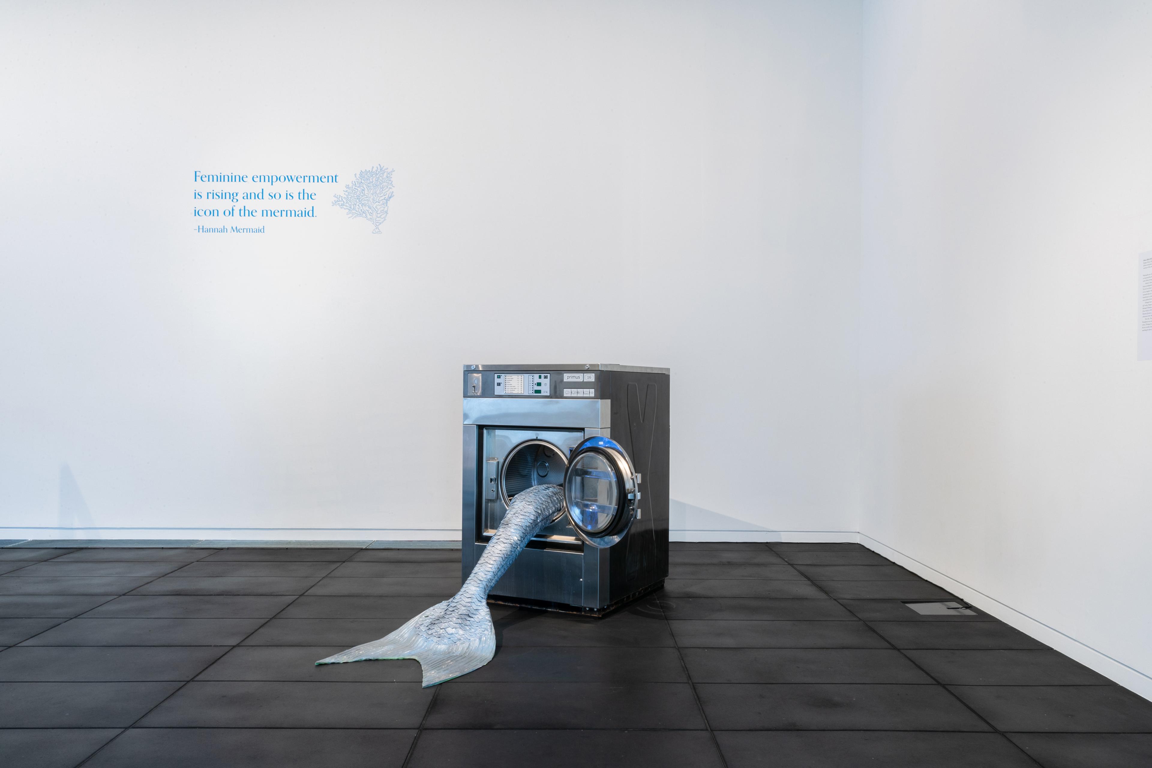 Olivia Erlanger, Pergusa (Gris), 2022, silicone and paint, commercial washing machine, courtesy of the artist and DM Office, New York. Installation view, Megan Dunn: The Mermaid Chronicles, Te Pātaka Toi Adam Art Gallery, Te Herenga Waka Victoria University of Wellington, 2022. Photo: Ted Whitaker