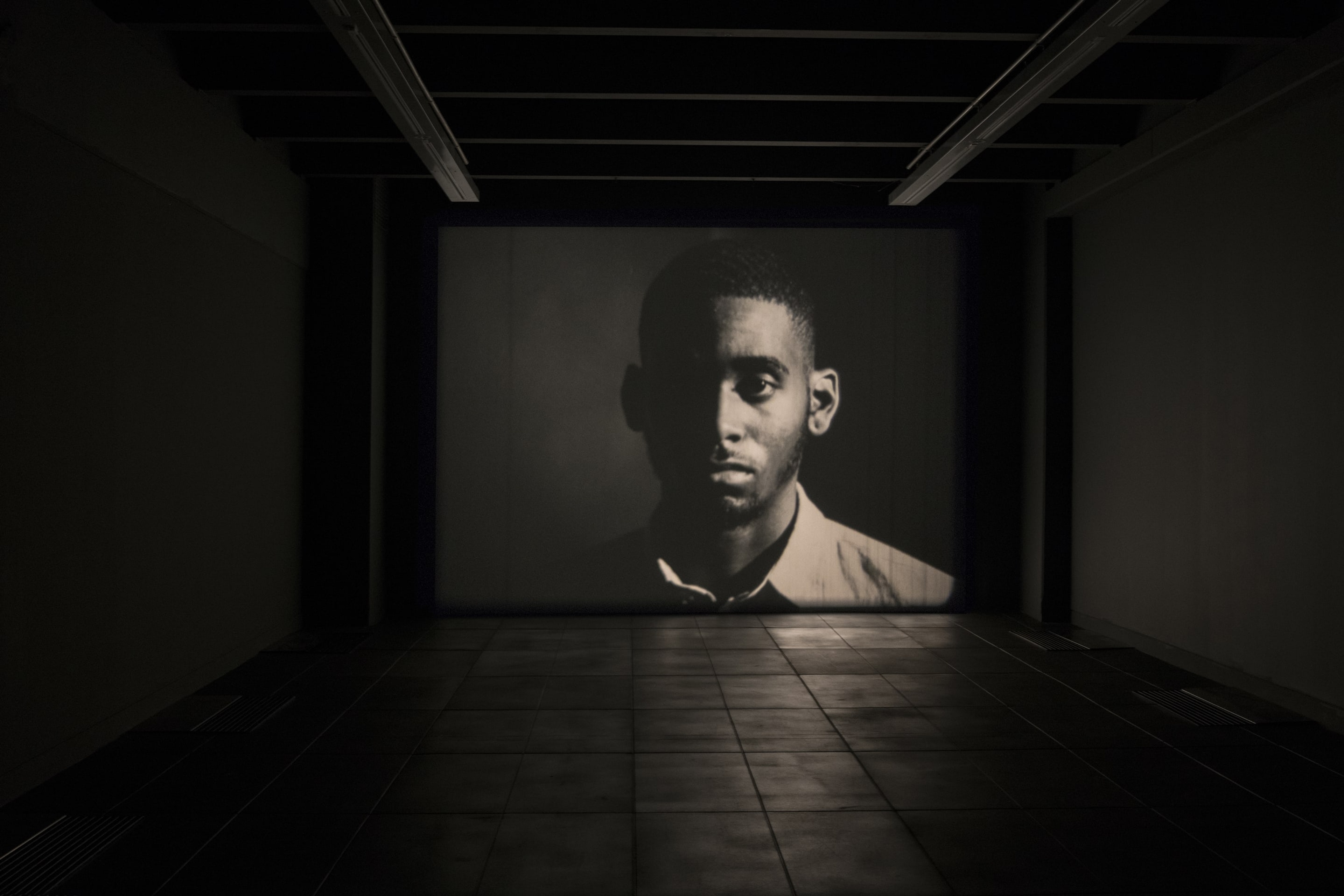 Luke Willis Thompson, Cemetery of Uniforms and Liveries, 2016, 16mm, b&w film, silent, 8 minutes, 50 seconds @ 24 fps. Installation view at Adam Art Gallery Te Pātaka Toi, Victoria University of Wellington