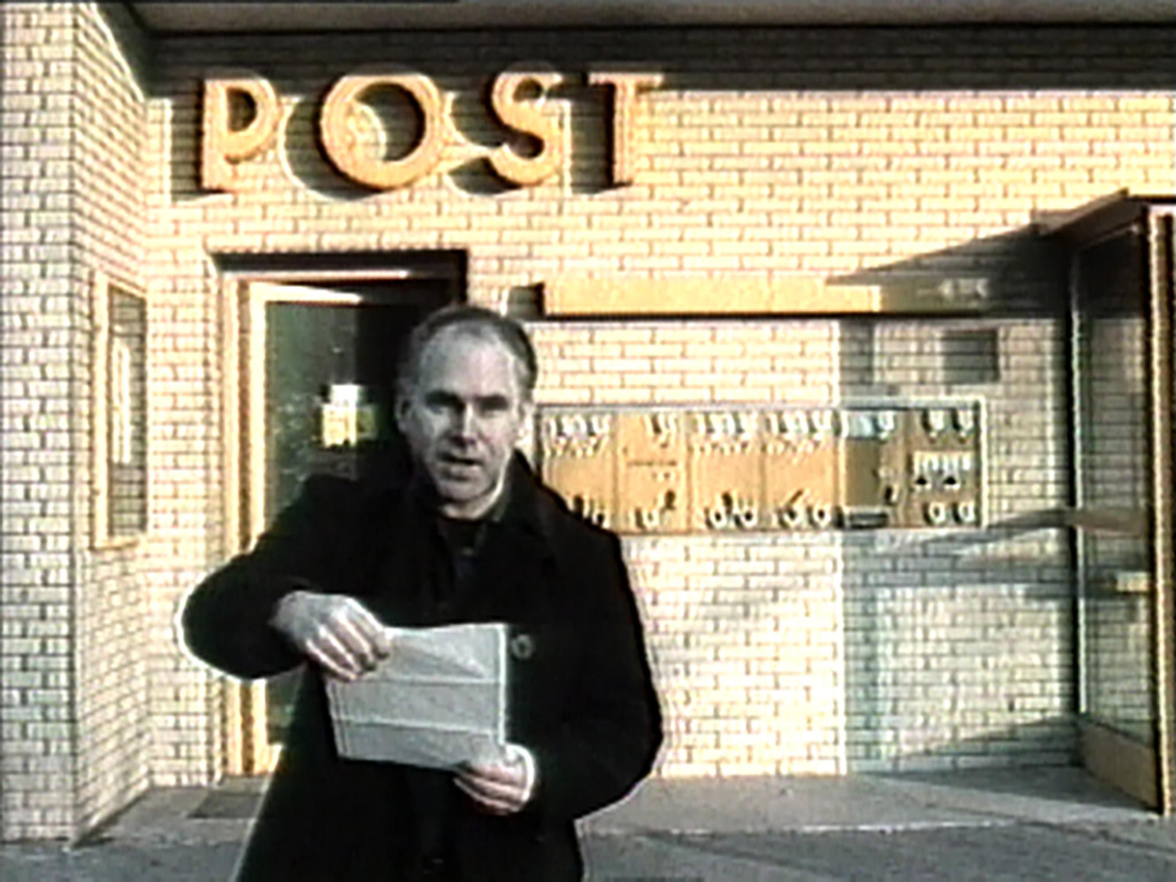 Video still showing Stuart Sherman outside post office