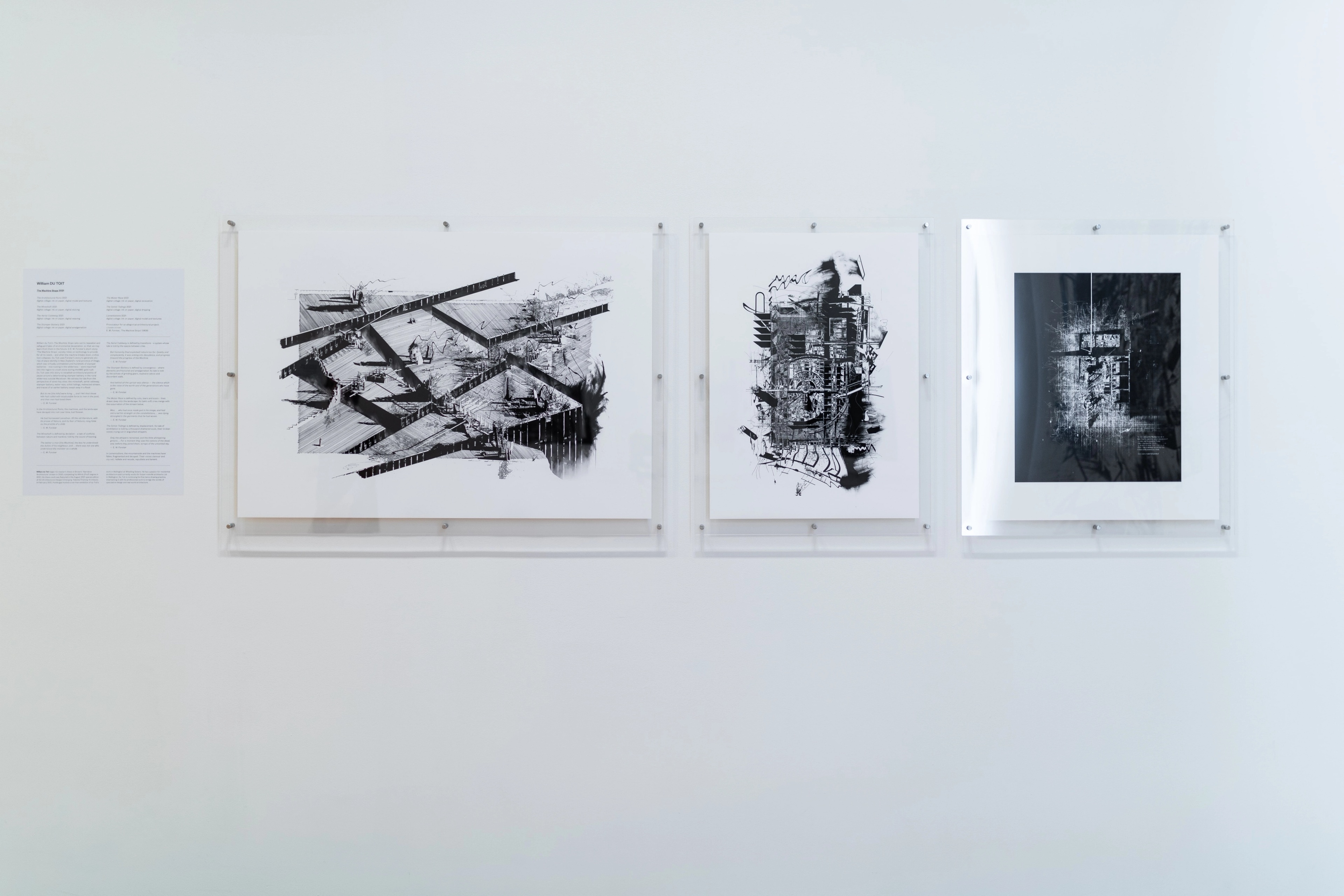 Straight on view of a gallery wall with text and square architectural images in perspex mounts. Daniel K. Brown 