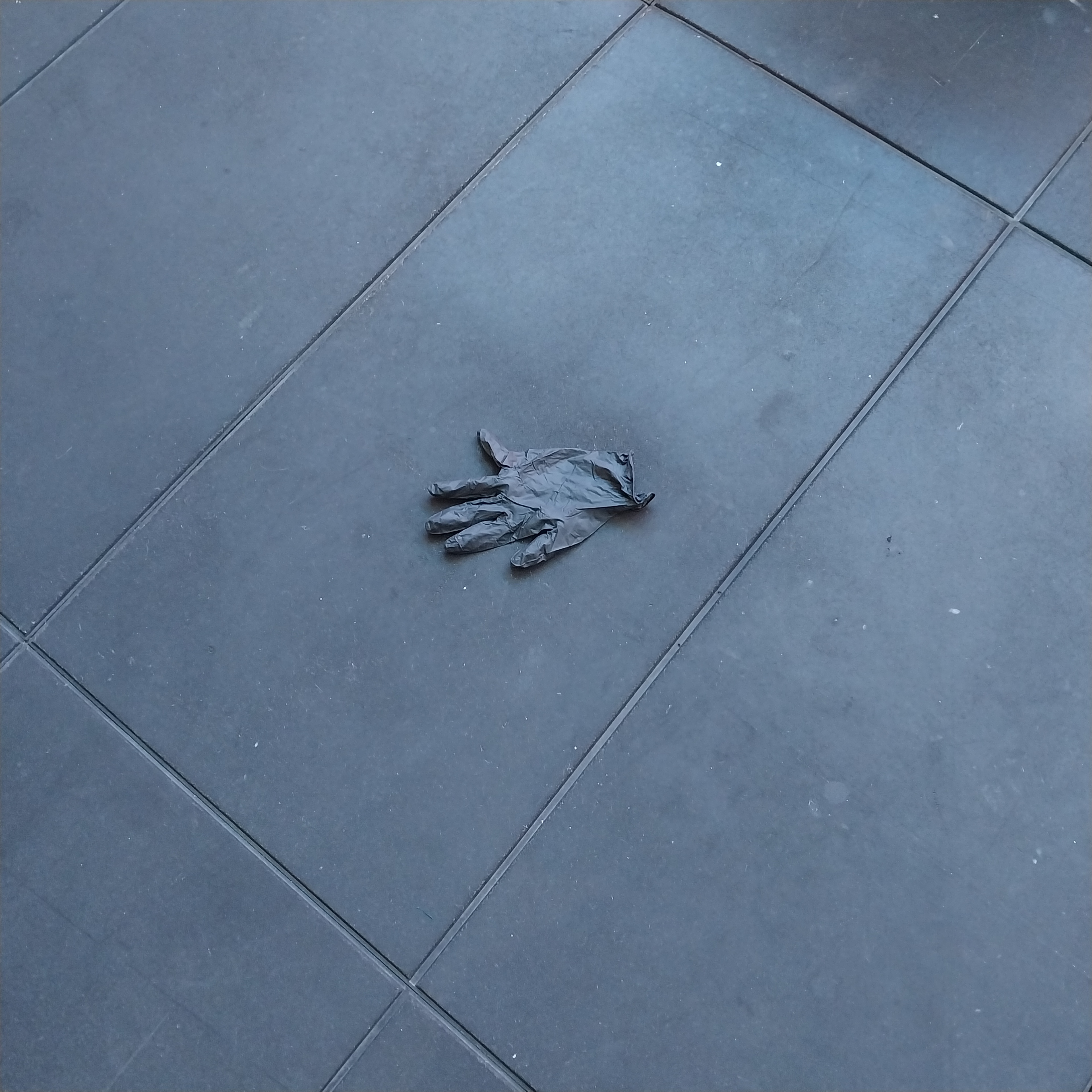 Black glove on black rubber floor