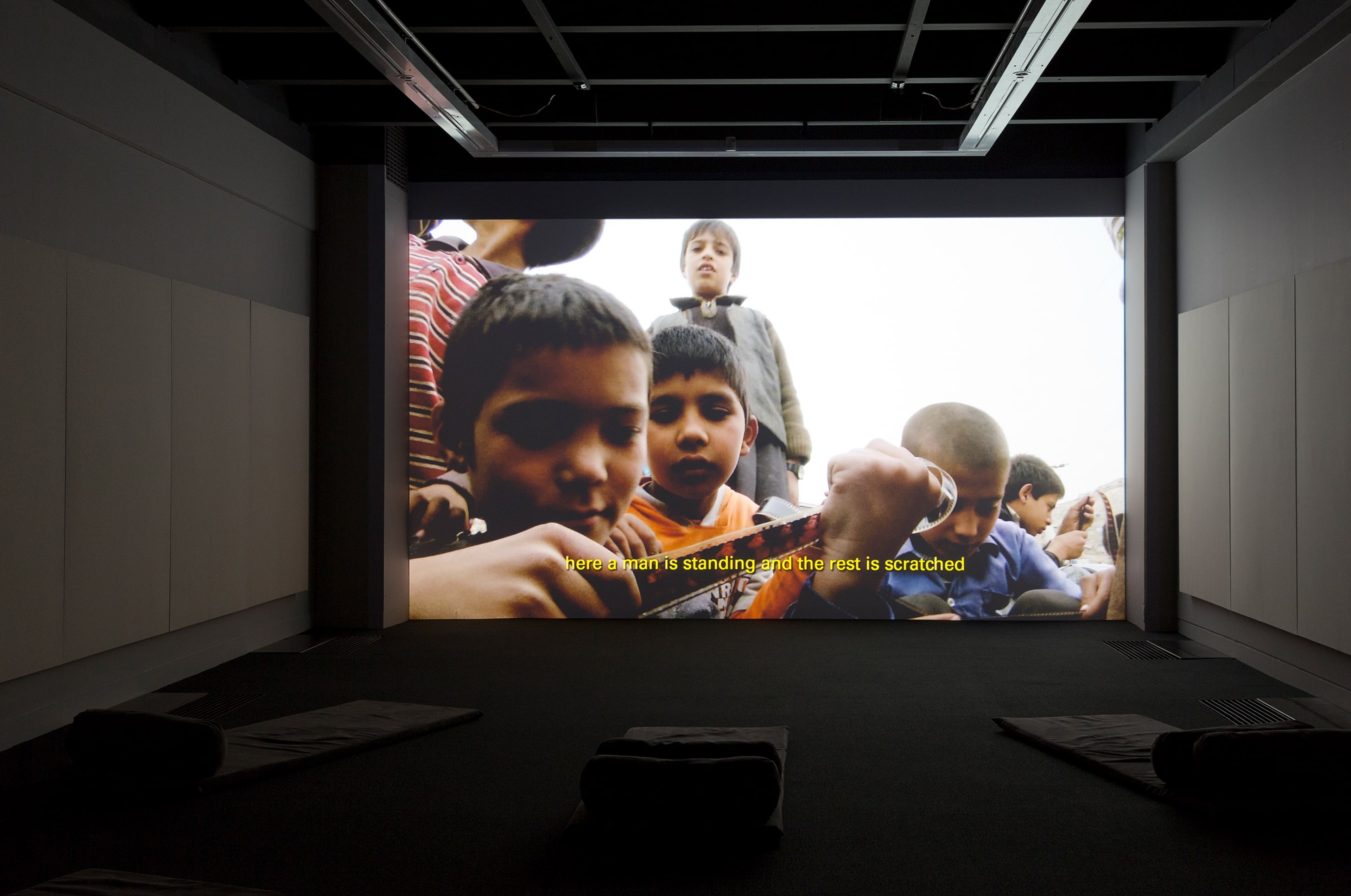 Installation view of Francis Alÿs (in collaboration with Julien Devaux and Ajmal Maiwandi), Reel-Unreel (2011) at the Adam Art Gallery. Single channel video projection, 19:28min, color, sound. Photo: Shaun Waugh.
