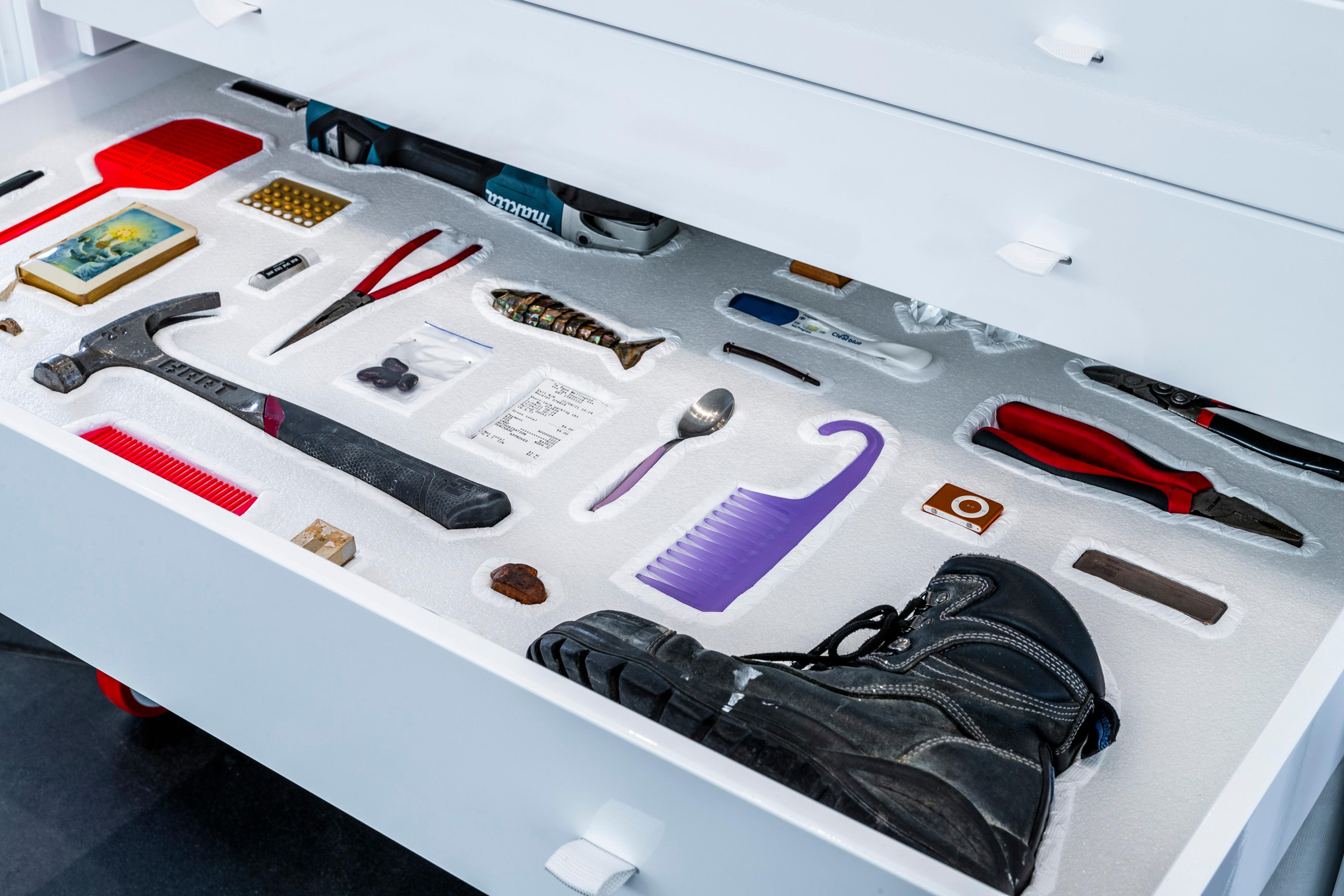 Colour photograph of nested objects in the drawer of a custom cabinet