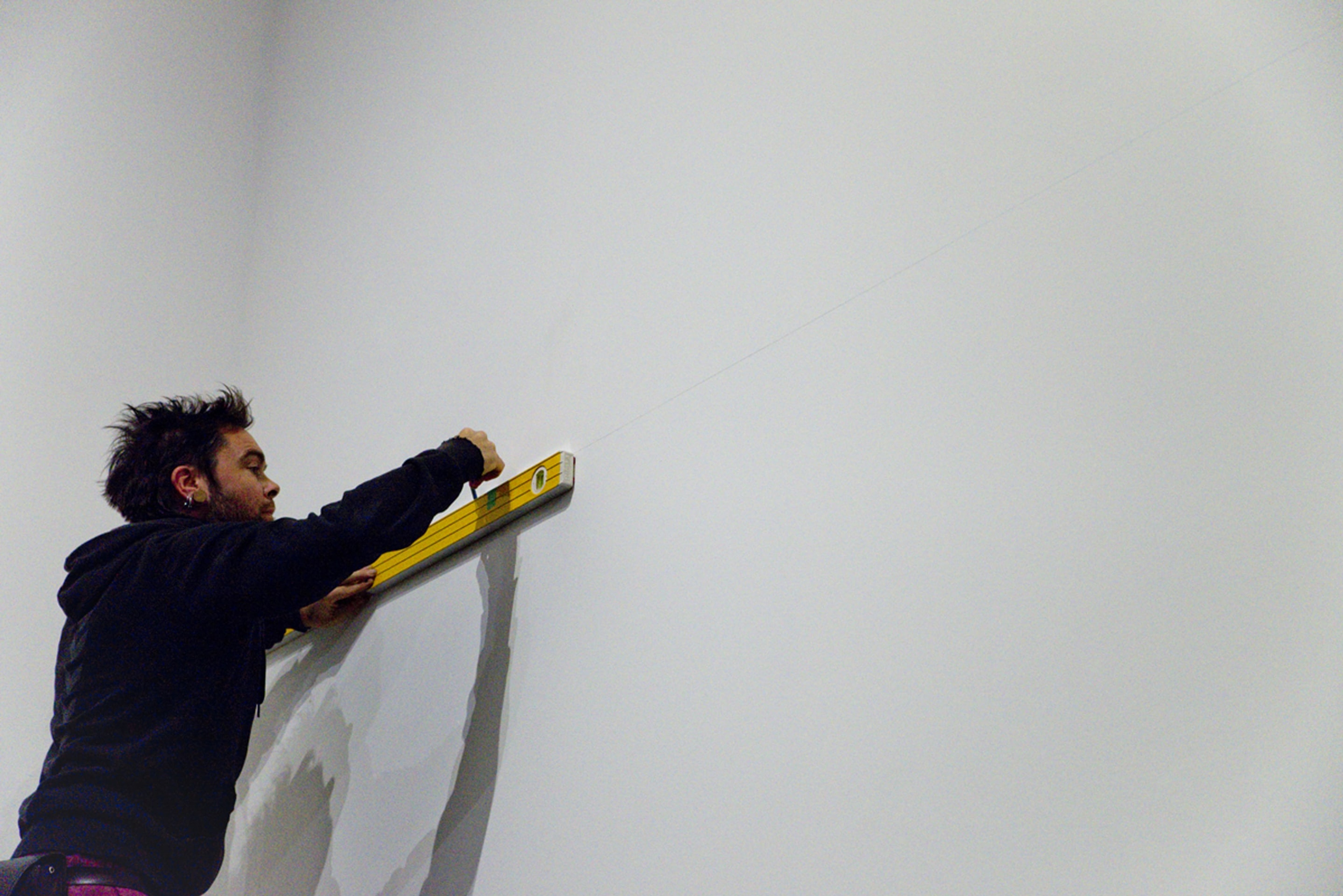 Installation of Julian Dashper Untitled (Black: for Fred Sandback, 2001–08) 2016, editions #2–10, black coloured pencil on wall, and Untitled (Blue: for Fred Sandback, 2001–08) 2016, editions #2–10, blue coloured pencil on wall. Courtesy of the Estate of Julian Daspher and Michael Lett, Auckland. Photographed during exhibition opening for Inhabiting Space at Adam Art Gallery Te Pātaka Toi, Victoria University of Wellington 13/05/16. (photo: Shaun Matthews)
