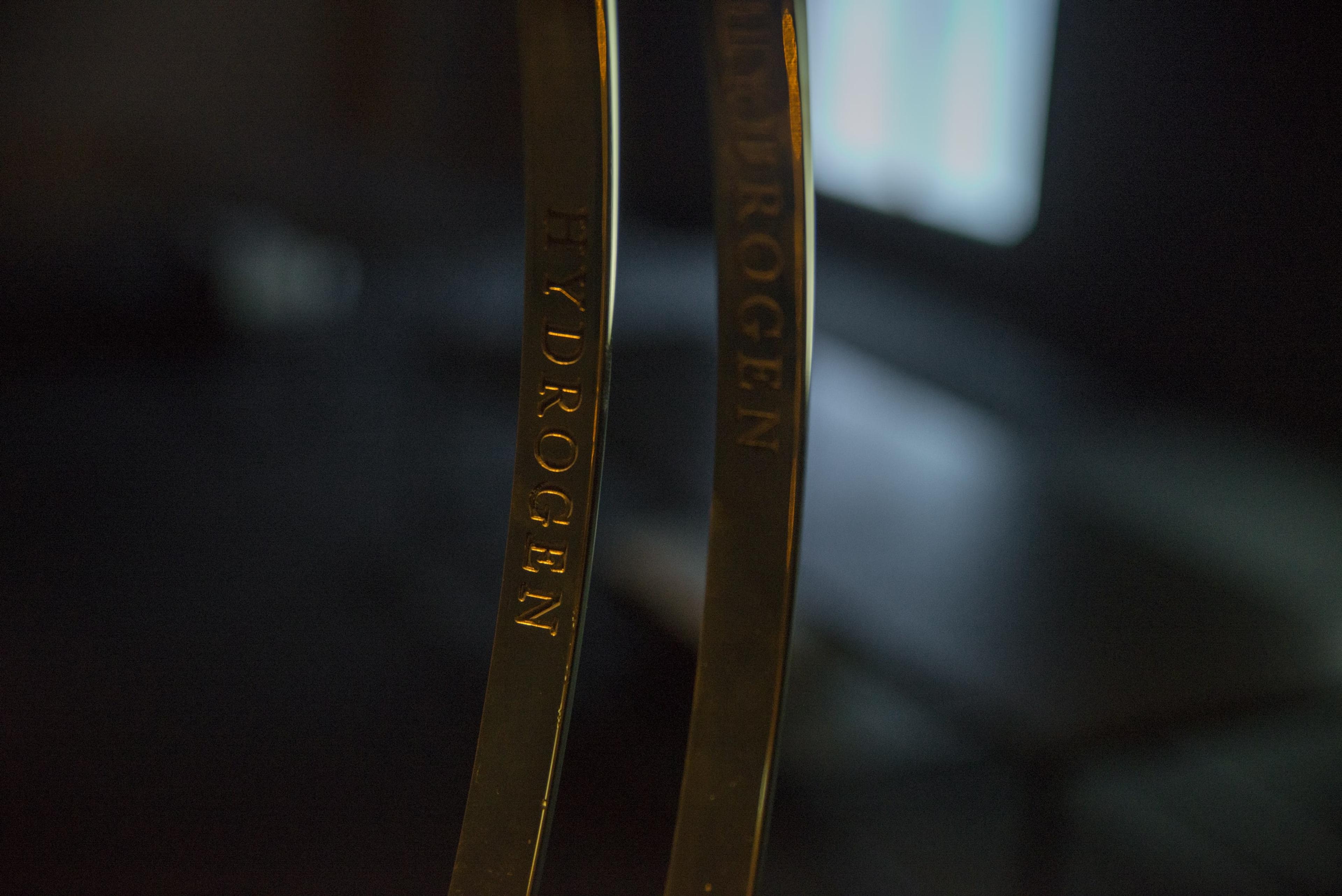 Installation view of Dane Mitchell, Structural Formula, Water Molecule, 2015, brass, Victoria University of Wellington Art Collection, purchased 2018, in the exhibition Solid State: Works from the Victoria University of Wellington Art Collection, 6 October – 20 December 2018, Adam Art Gallery Te Pātaka Toi.