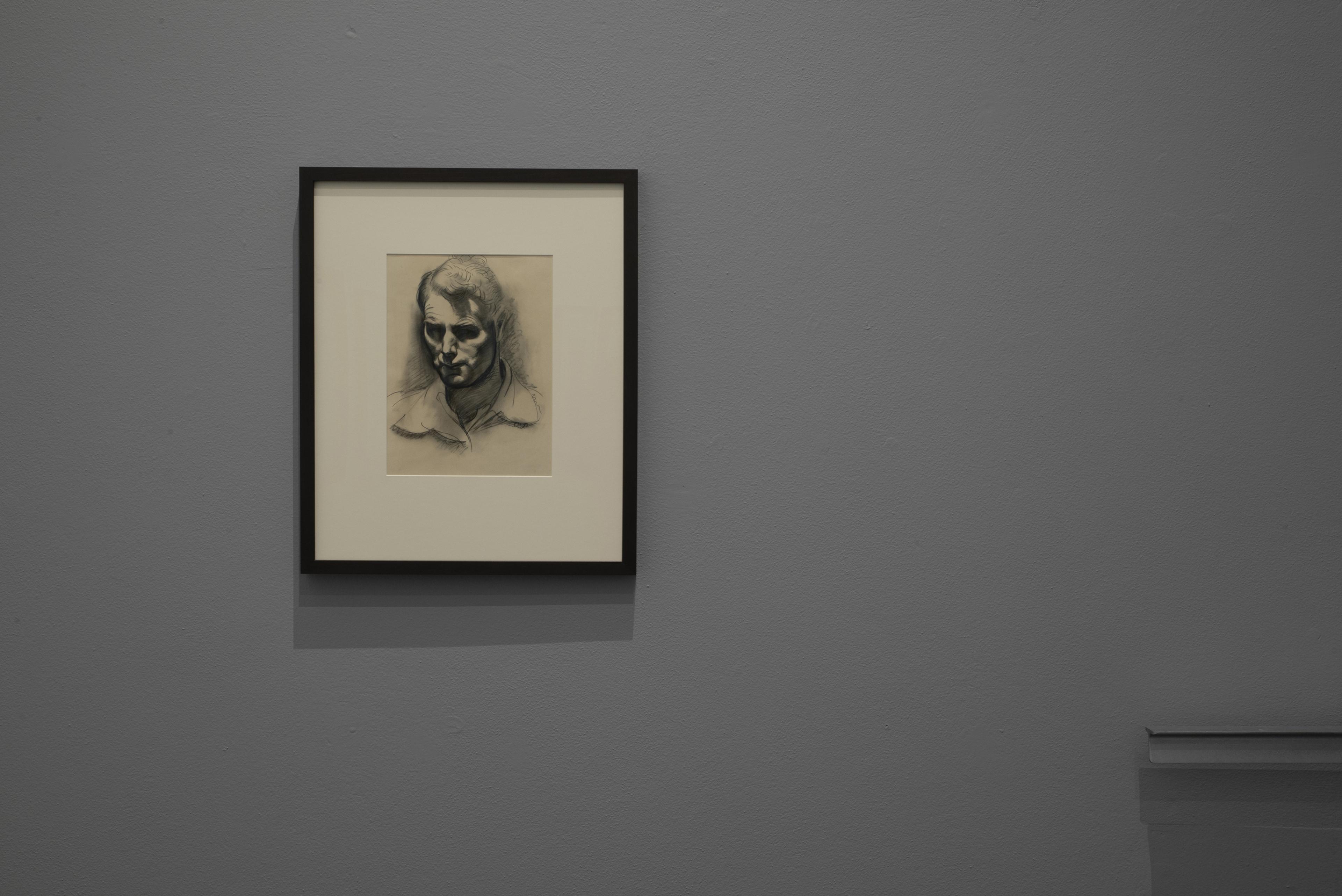 Christopher Perkins, Self-portrait, circa 1930, charcoal on card, Collection of Museum of New Zealand Te Papa Tongarewa, gift of P.W. Robertson, 1951. Installation view, ‘Looking for a new country’ – Christopher Perkins in New Zealand, Adam Art Gallery Te Pātaka Toi, Victoria University of Wellington, 6 November 2019 – 22 March 2020. Photo: Shaun Matthews