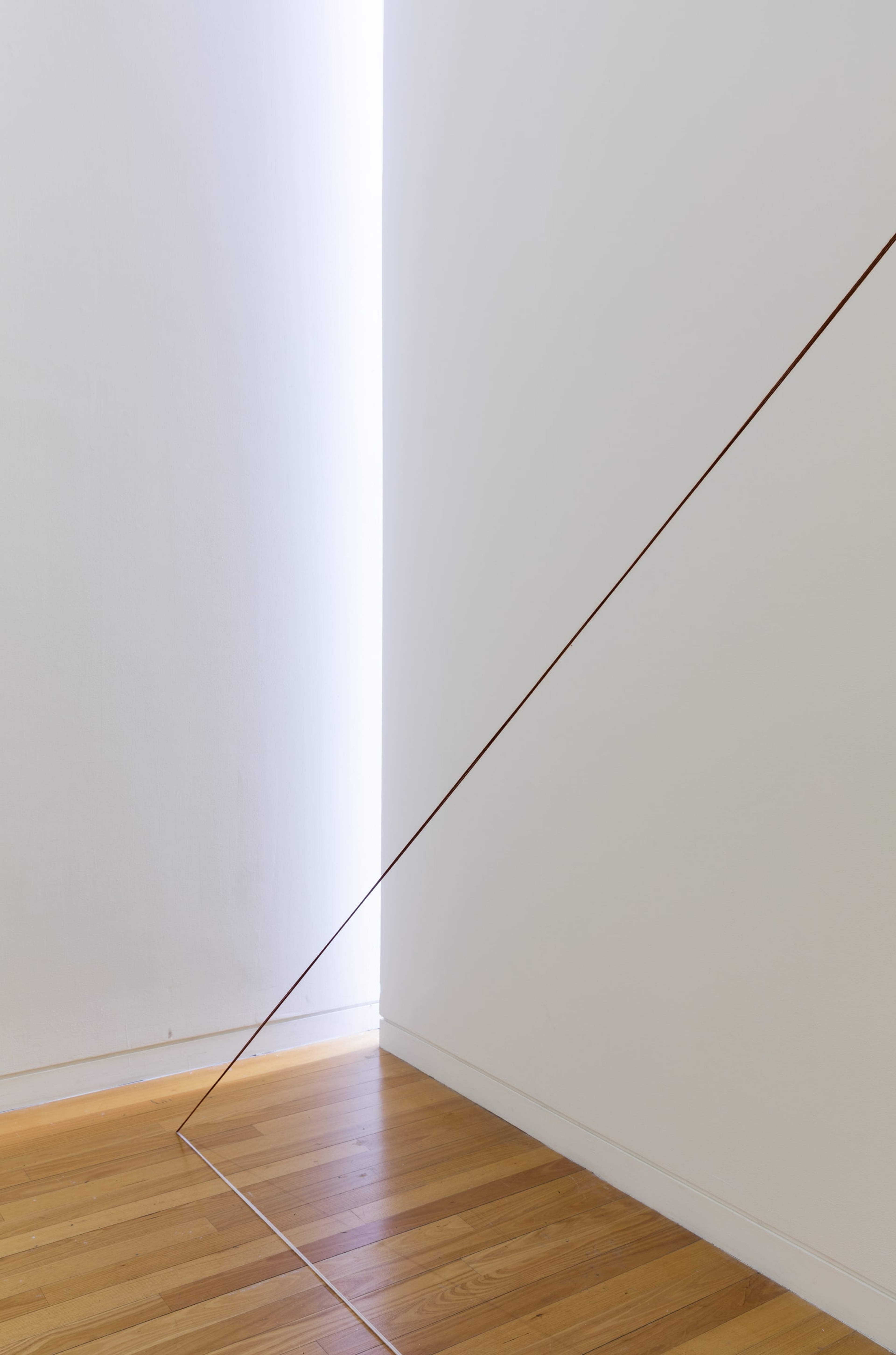Detail view of Fred Sandback, Untitled (Triangle with Broken Leg) 1988, acrylic yarn. Courtesy of the Fred Sandback Estate, Jensen Gallery, Sydney and Fox/Jensen, Auckland. In the exhibition Inhabiting Space at the Adam Art Gallery Te Pātaka Toi, Victoria University of Wellington (photo: Shaun Waugh)