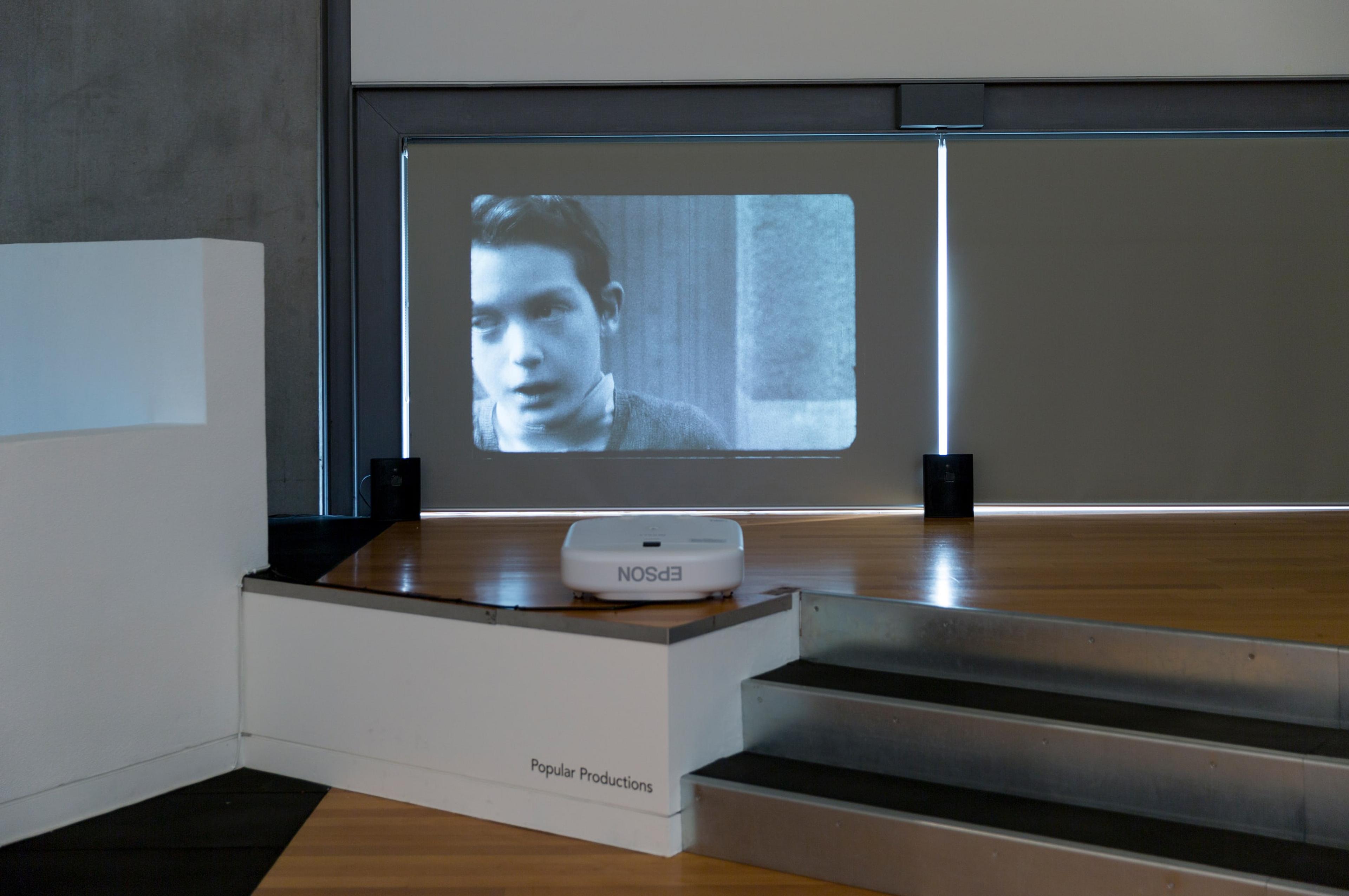 Popular Productions the story of, 1973, digital transfer of 8mm film, black and white, silent, 6mins 23secs, courtesy of Popular Productions and Michael Lett, Auckland. In Fragments of a World, curated by Sandy Callister, Adam Art Gallery Te Pātaka Toi, Victoria University of Wellington (photo: Shaun Waugh)