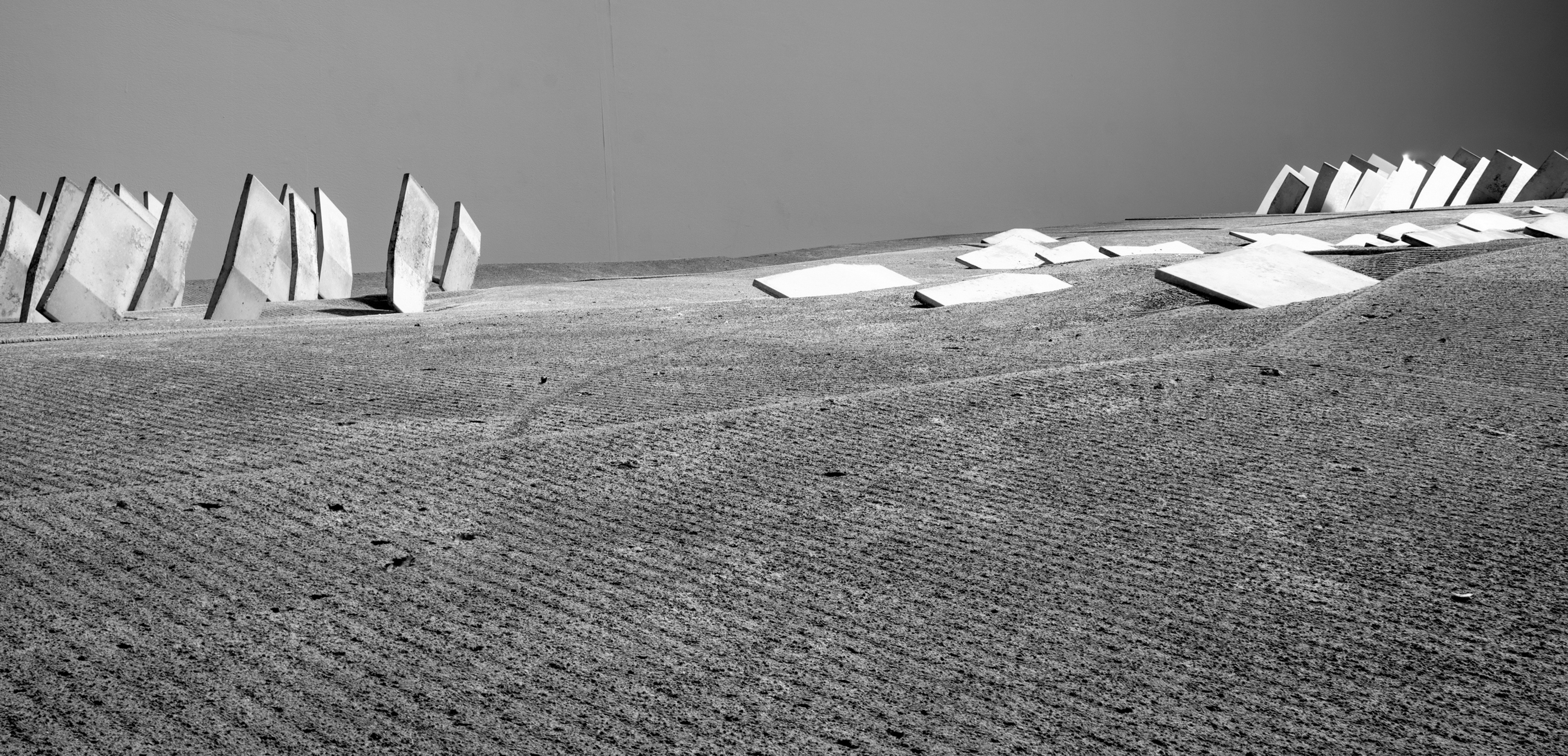 Architectural drawing of a fragmented wall within a landscape.