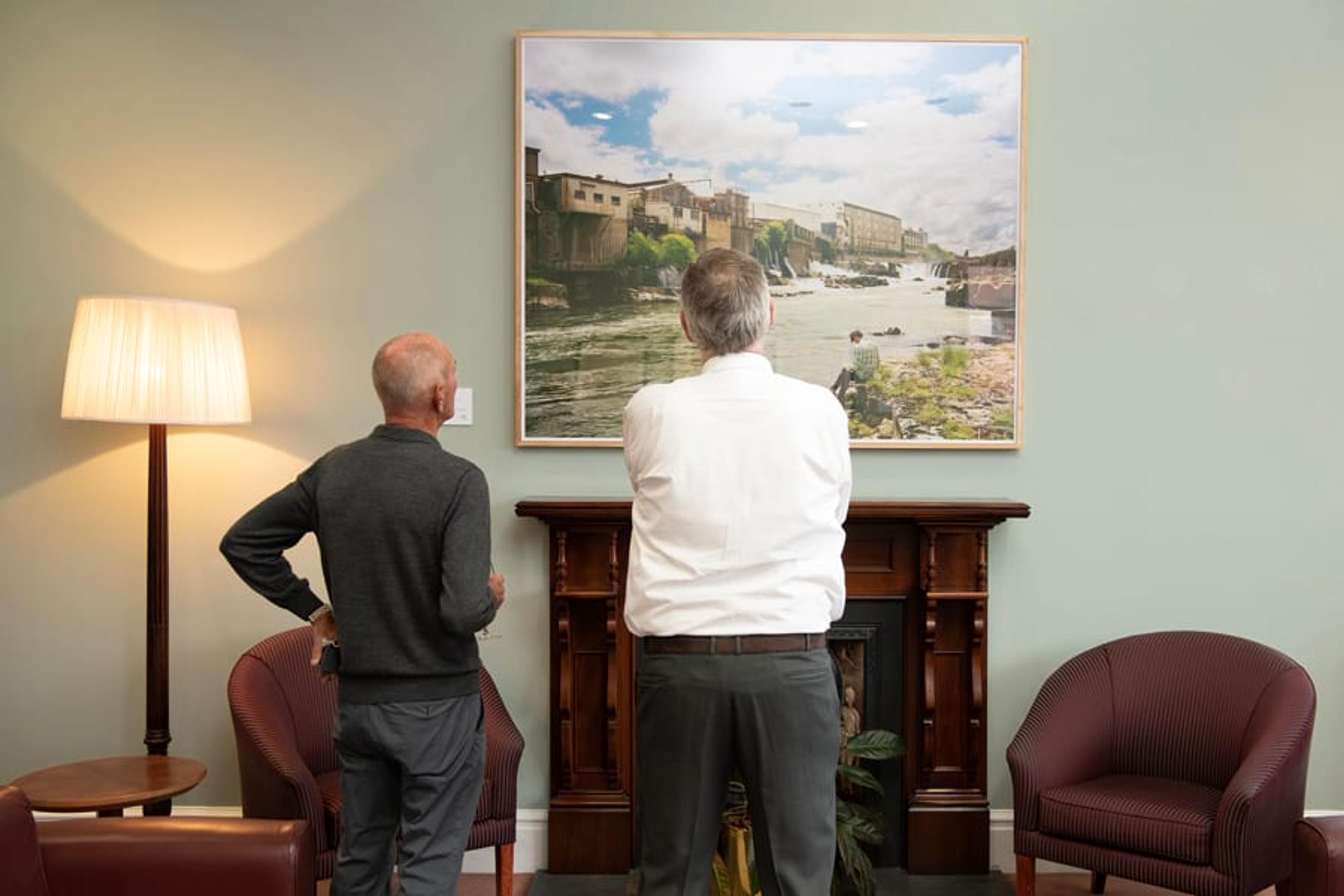 Gallery Patrons view new acquisition to the Ngā Puhipuhi o Te Herenga Waka—Victoria University of Wellington Collection, Chris Corson-Scott’s A Poet Writing Before the Falls and Freezing Works, Mataura, (2016), hanging in the Victoria Room, 23 November 2022. Photograph: Robert Cross.