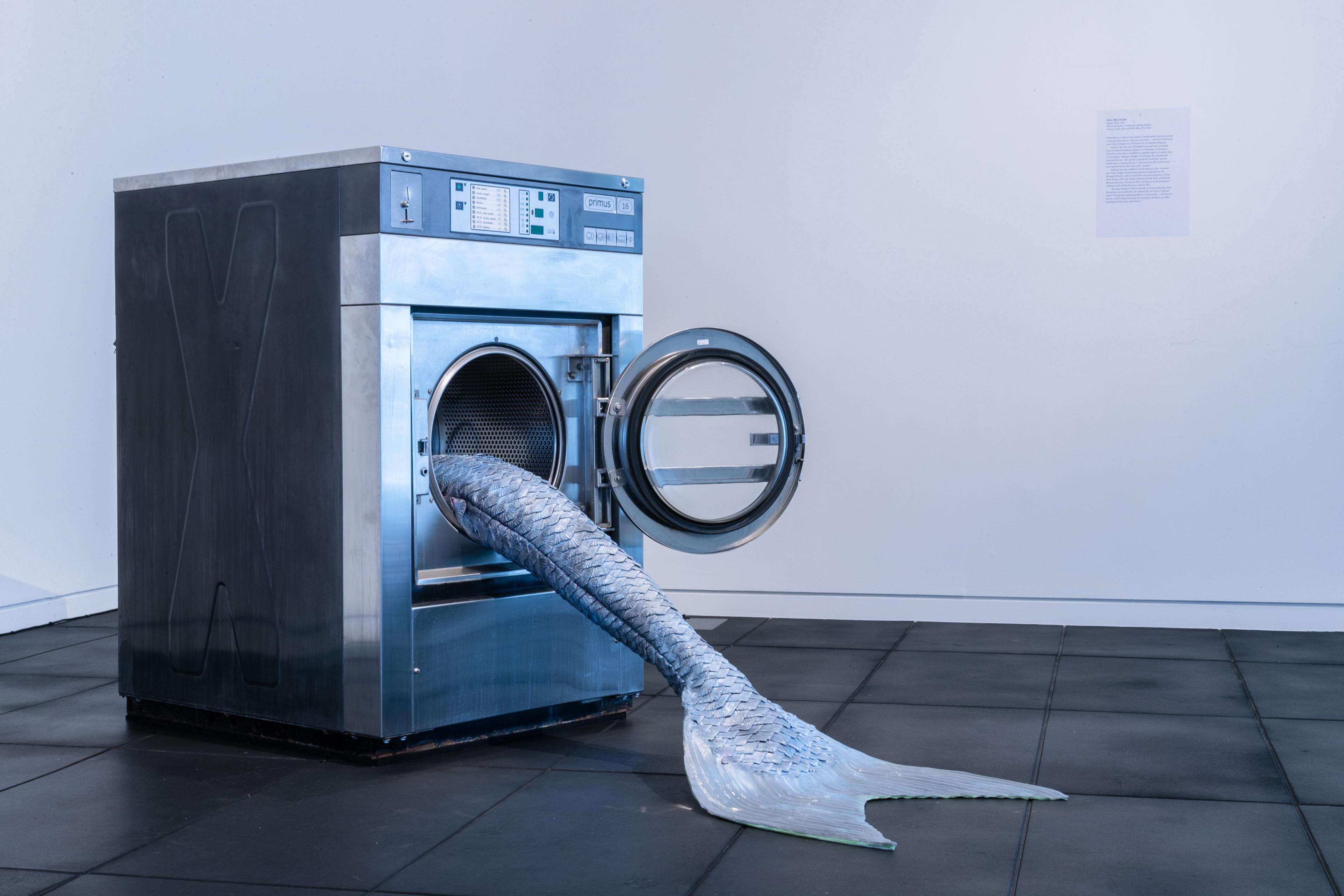 Olivia Erlanger, Pergusa (Gris), 2022, silicone and paint, commercial washing machine, courtesy of the artist and DM Office, New York. Installation view, Megan Dunn: The Mermaid Chronicles, Te Pātaka Toi Adam Art Gallery, Te Herenga Waka Victoria University of Wellington, 2022. Photo: Ted Whitaker