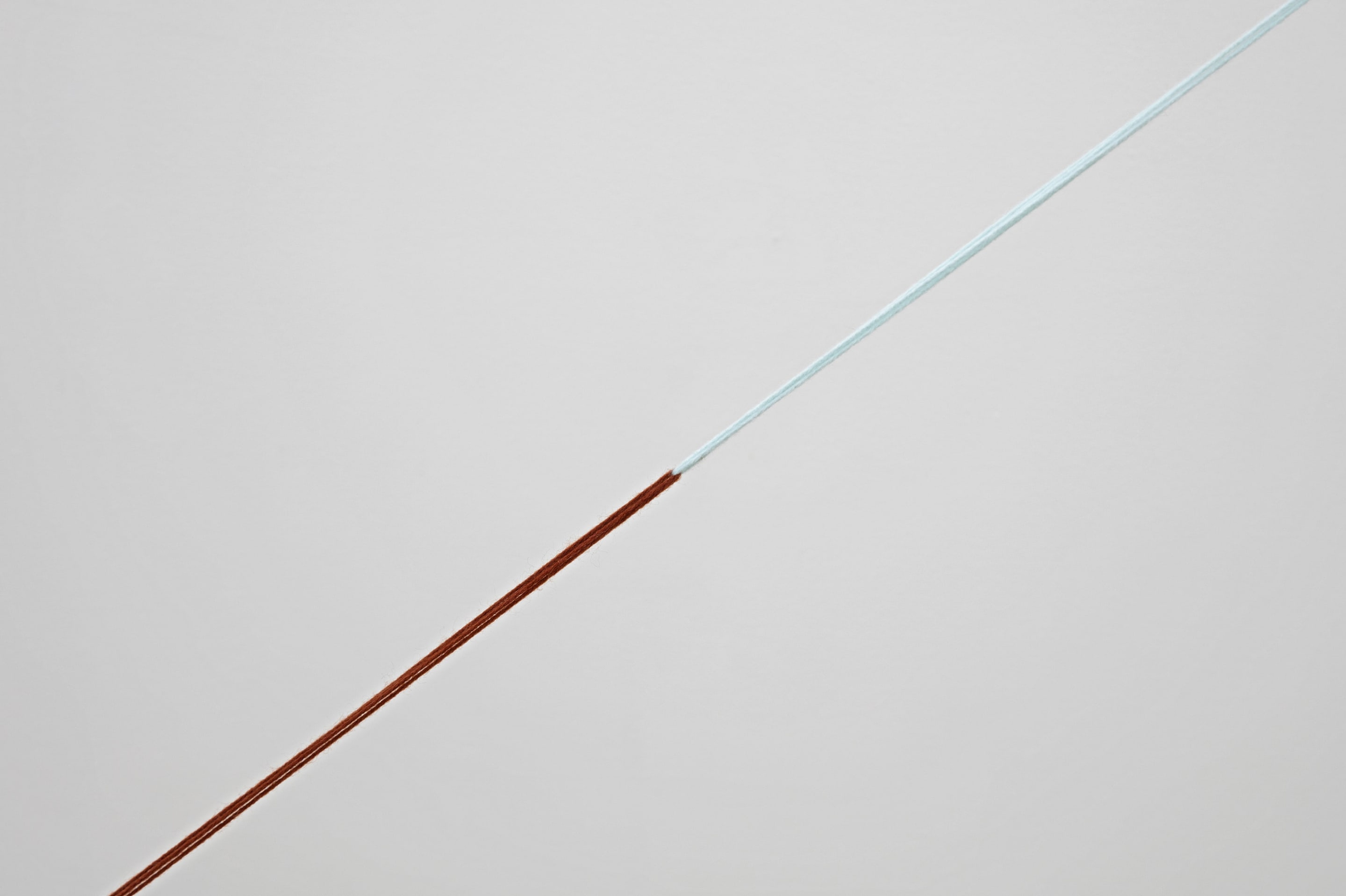 Detail view of Fred Sandback, Untitled (Triangle with Broken Leg) 1988, acrylic yarn. Courtesy of the Fred Sandback Estate, Jensen Gallery, Sydney and Fox/Jensen, Auckland. In the exhibition Inhabiting Space at the Adam Art Gallery Te Pātaka Toi, Victoria University of Wellington (photo: Shaun Waugh)
