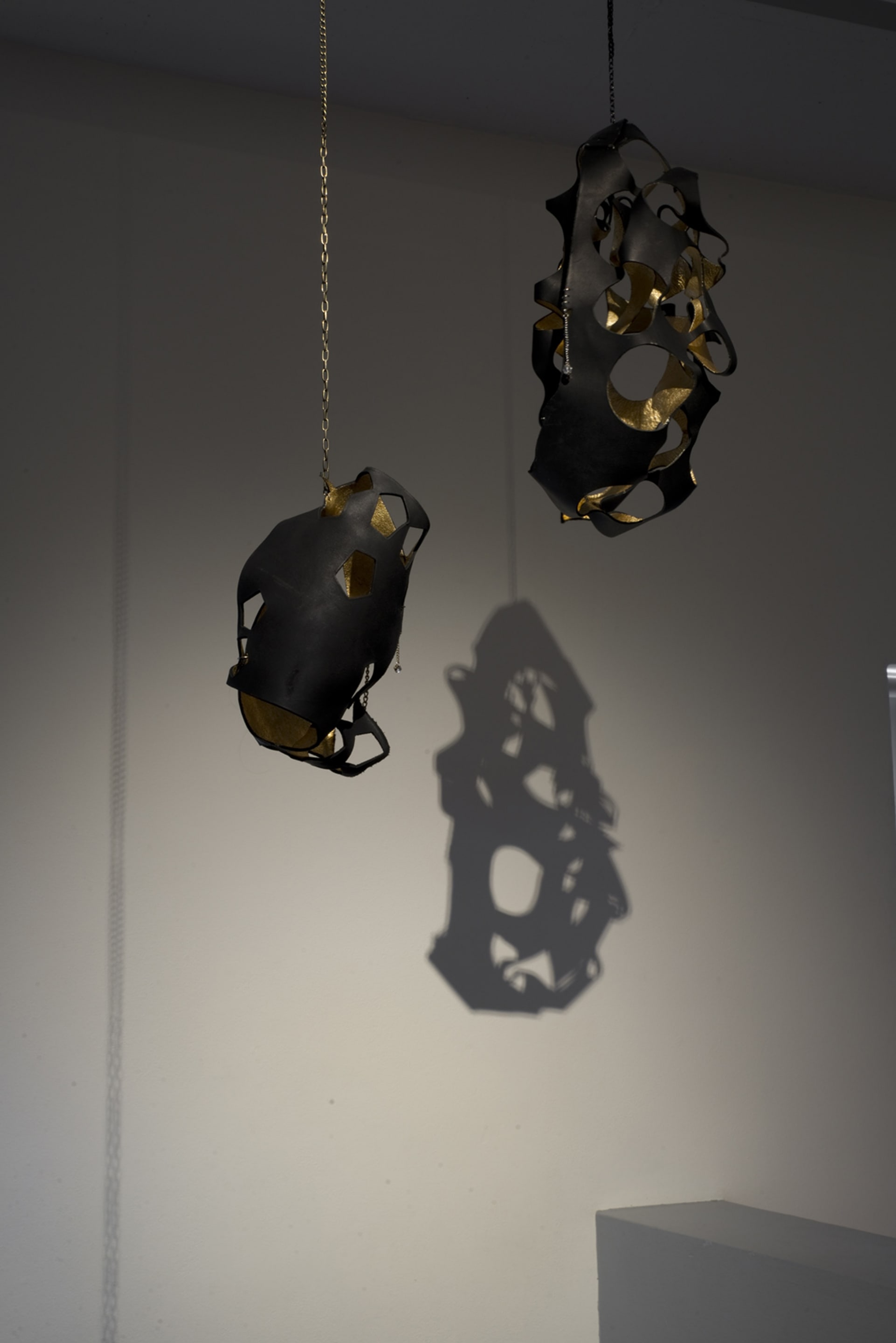 Signe Rose, Bondage Jewel 2016 and Bondage Egg 2015, gold leaf, leather, chain, jewellery findings. Courtesy of the artist, on view in Acting Out at Adam Art Gallery Te Pātaka Toi, photo: Shaun Matthews