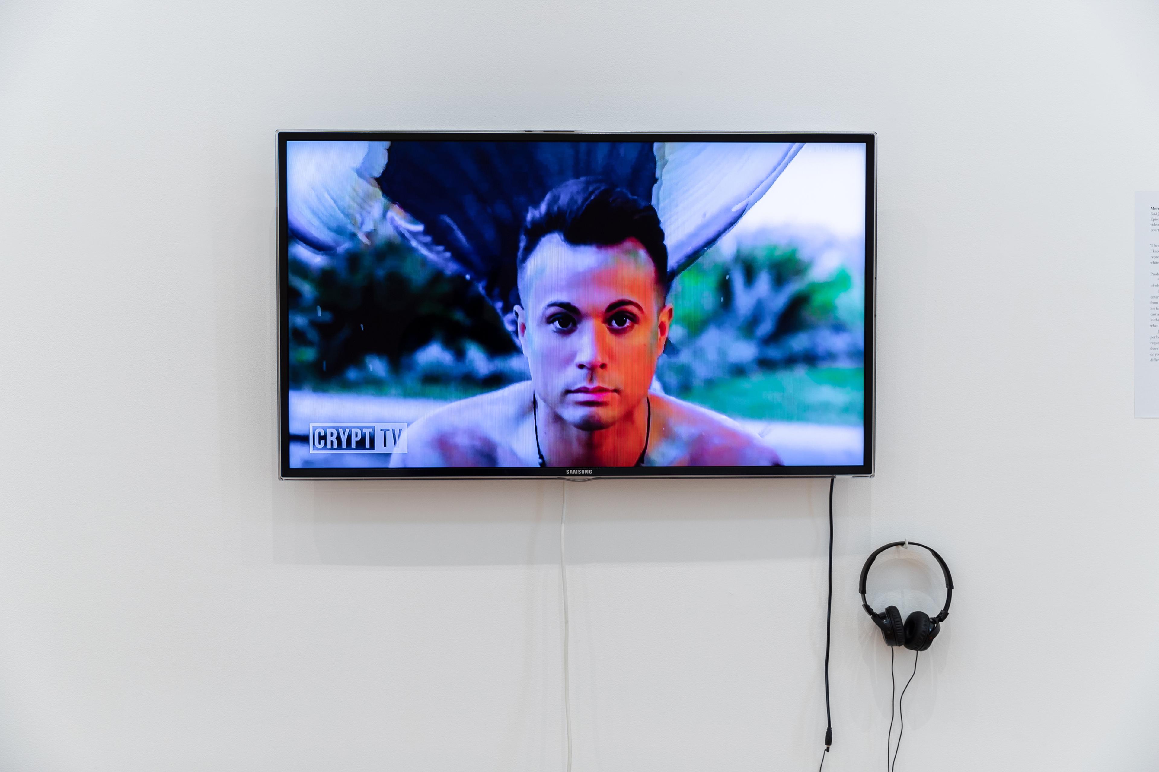 Merman Jax, Odd Jobs: Merman , 2017, Episode 4, Crypt TV Facebook Series, video, colour, sound, 2 mins, 6 sec. Courtesy of Crypt TV and Jack Laflin.  Installation view, Megan Dunn: The Mermaid Chronicles, Te Pātaka Toi Adam Art Gallery, Te Herenga Waka Victoria University of Wellington, 2022. Photo: Ted Whitaker