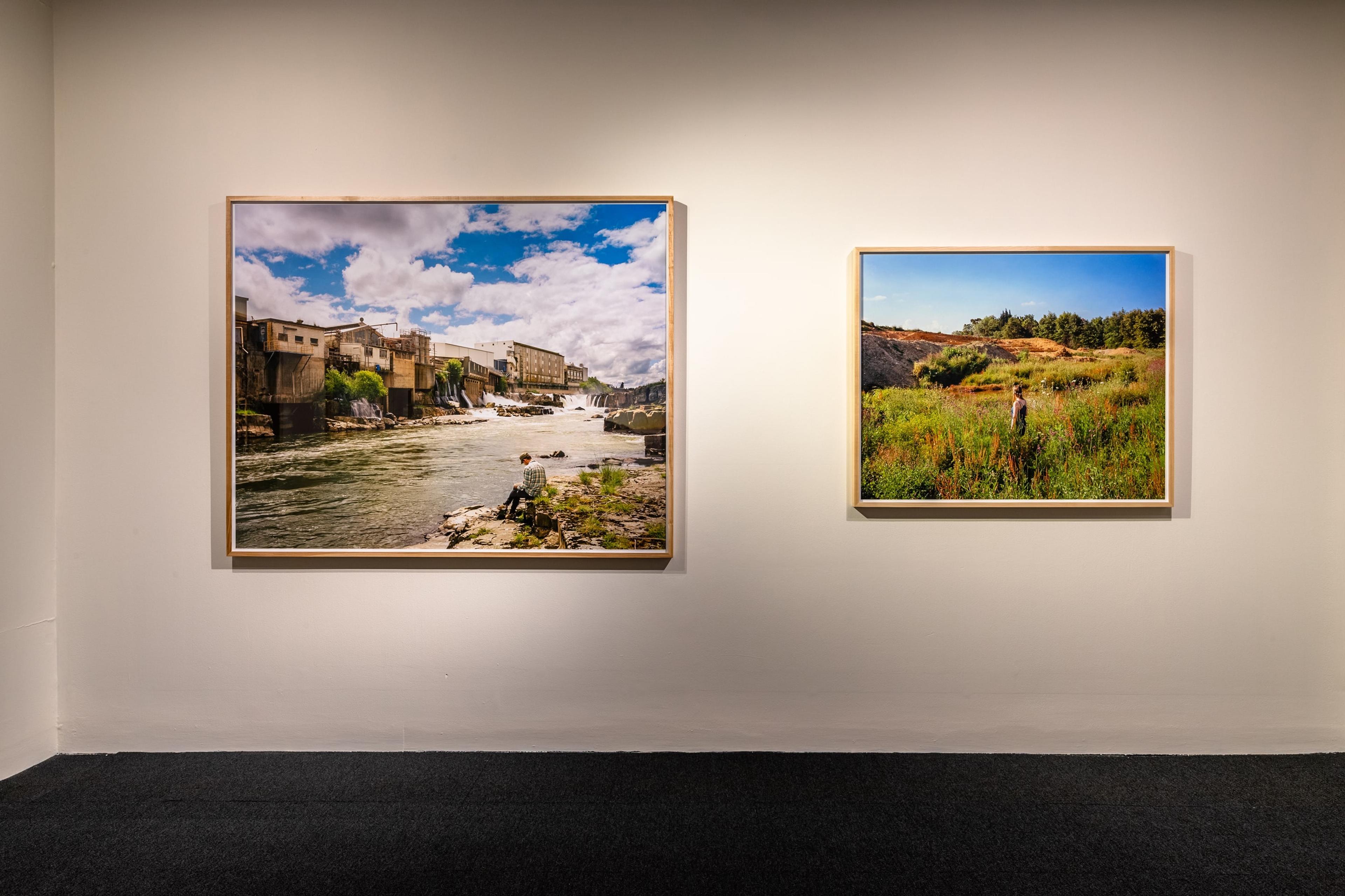 Chris Corson-Scott, A Poet Writing before the Falls and Freezing Work, Mataura, 2016, archival pigment print, 1400 × 1700mm; and Wildflowers in a Housing Development, Katikati, Bay of Plenty, 2015, archival pigment print, 1100 × 1350mm. Courtesy of the artist and Trish Clark Gallery, Auckland. Installation view, Tēnei Ao Tūroa – This Enduring World, Te Pātaka Toi Adam Art Gallery, Victoria University Wellington. Photo: Ted Whitaker