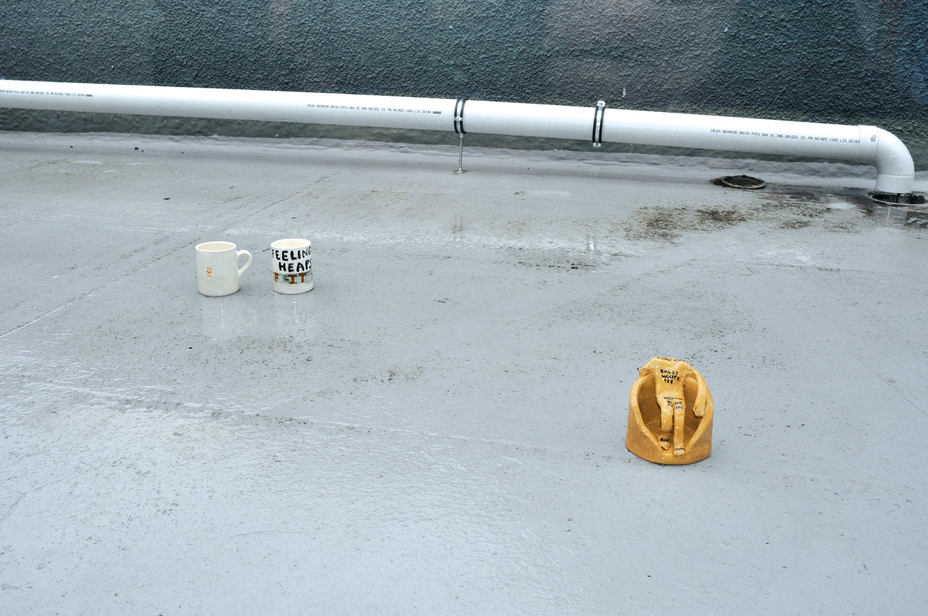 Kate Newby, Falling over with surprise, 2009, carpet, sheets, oil, coffee stains, red wine, lip balm, wood, scaffolding, paint, ceramics. Installation view, The Future is Unwritten, Adam Art Gallery Te Pātaka Toi, Victoria University of Wellington, 2009