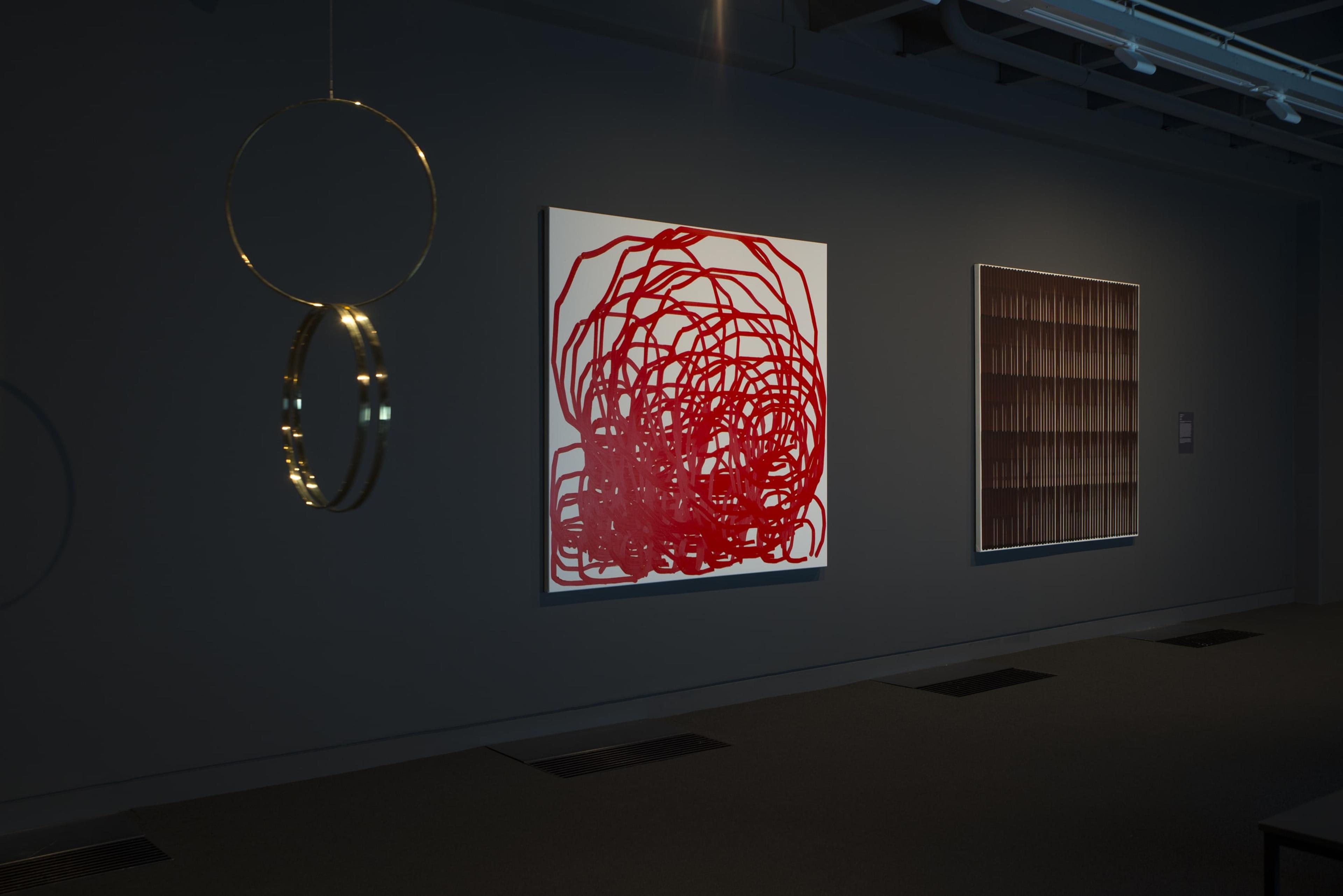 Installation view of Simon Ingram, Aldra Island, 2011, oil on canvas, and Ebino, 2011, oil on canvas, Victoria University of Wellington Art Collection, purchased 2018, partial gift of the artist and Gow Langsford Gallery; and Dane Mitchell, Structural Formula, Water Molecule, 2015, brass, Victoria University of Wellington Art Collection, purchased 2018, in the exhibition Solid State: Works from the Victoria University of Wellington Art Collection, 6 October – 20 December 2018, Adam Art Gallery Te Pātaka Toi.