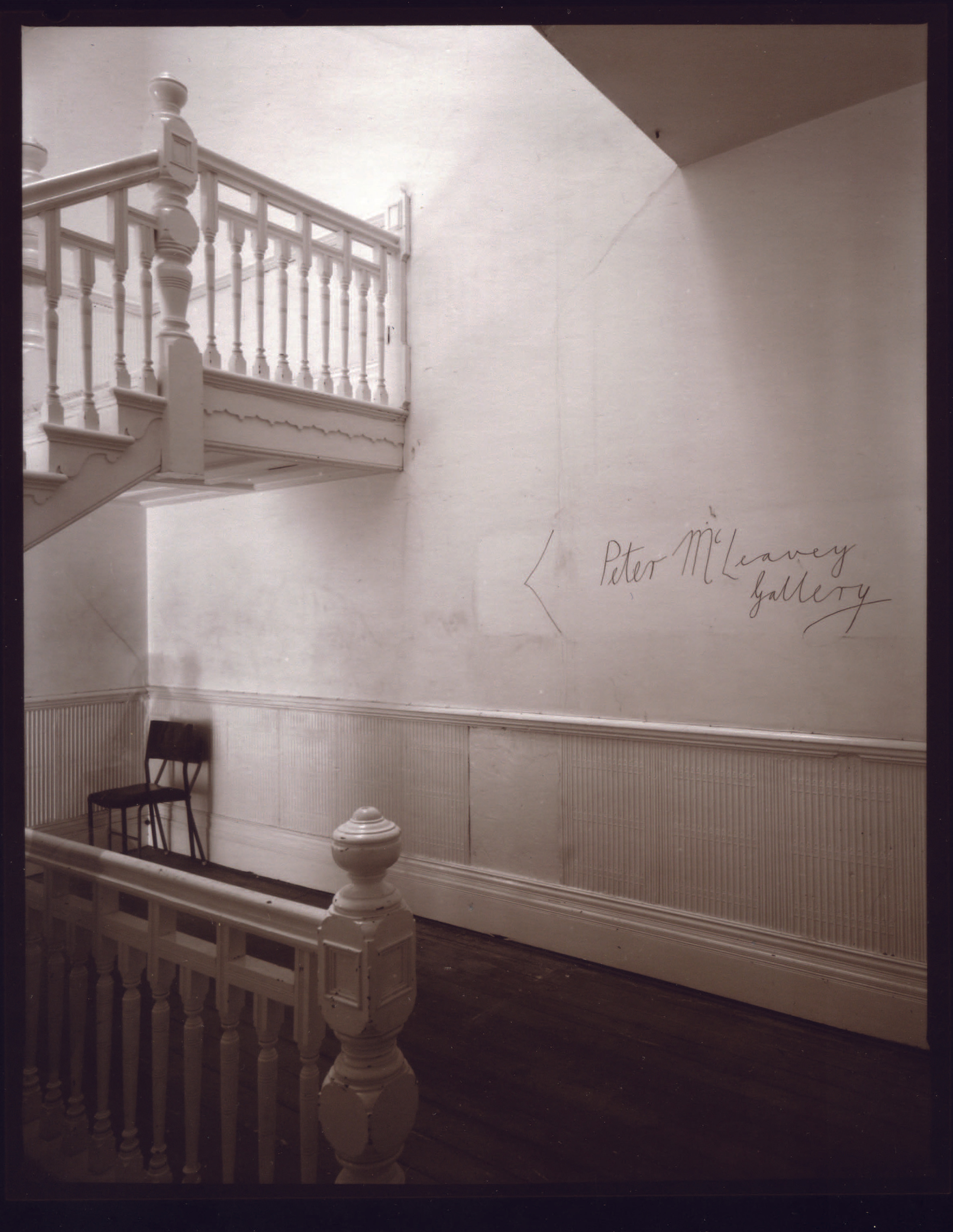 Andrew Ross, First floor landing, 147 Cuba St (with the original sign), 20/10/2001, 2001 gold-toned gelatin silver photograph (contact printed on printing-out paper), Collection of Peter McLeavey.