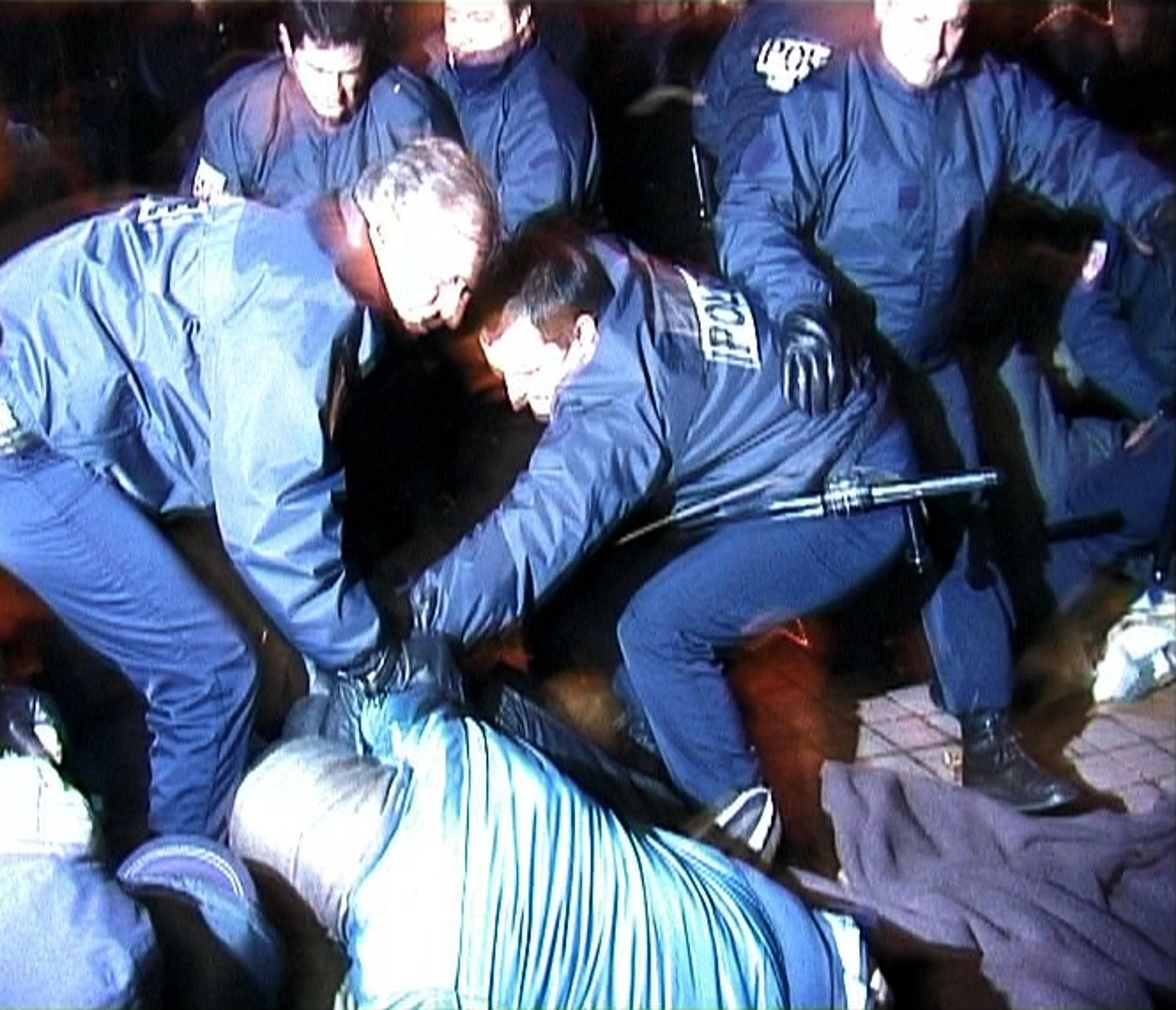 Police grabbing man off the ground