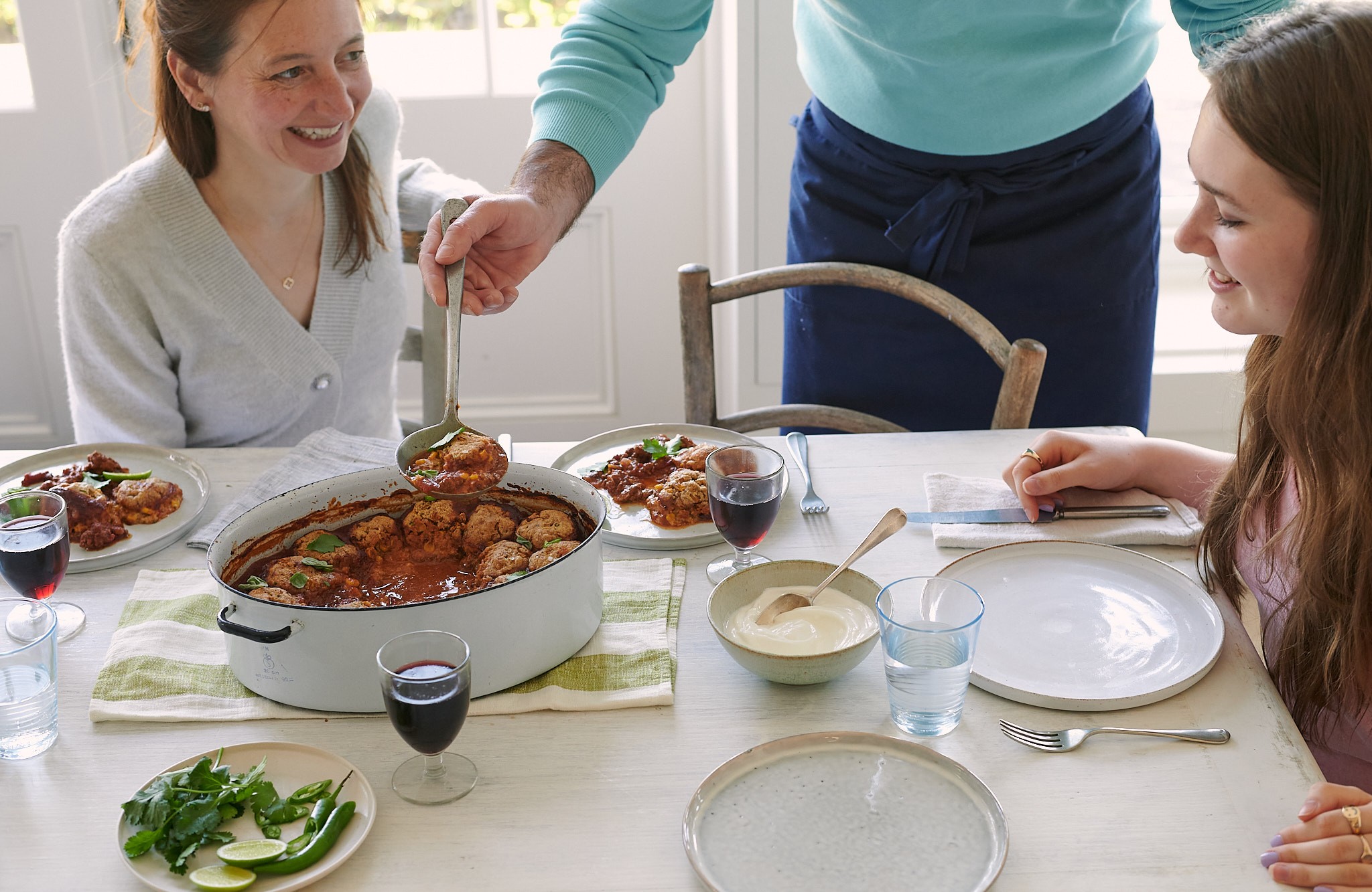 Jane Wareing and Jessie Wareing at a dining table with a casserole dish in front 