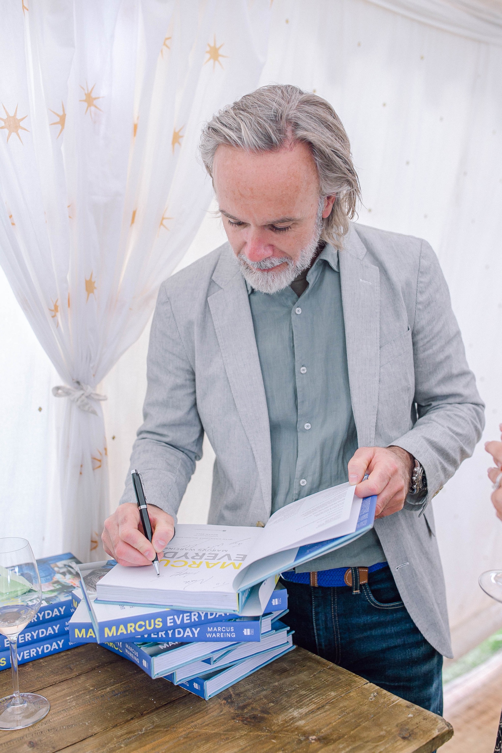 Marcus Wareing signing a book at a private event 