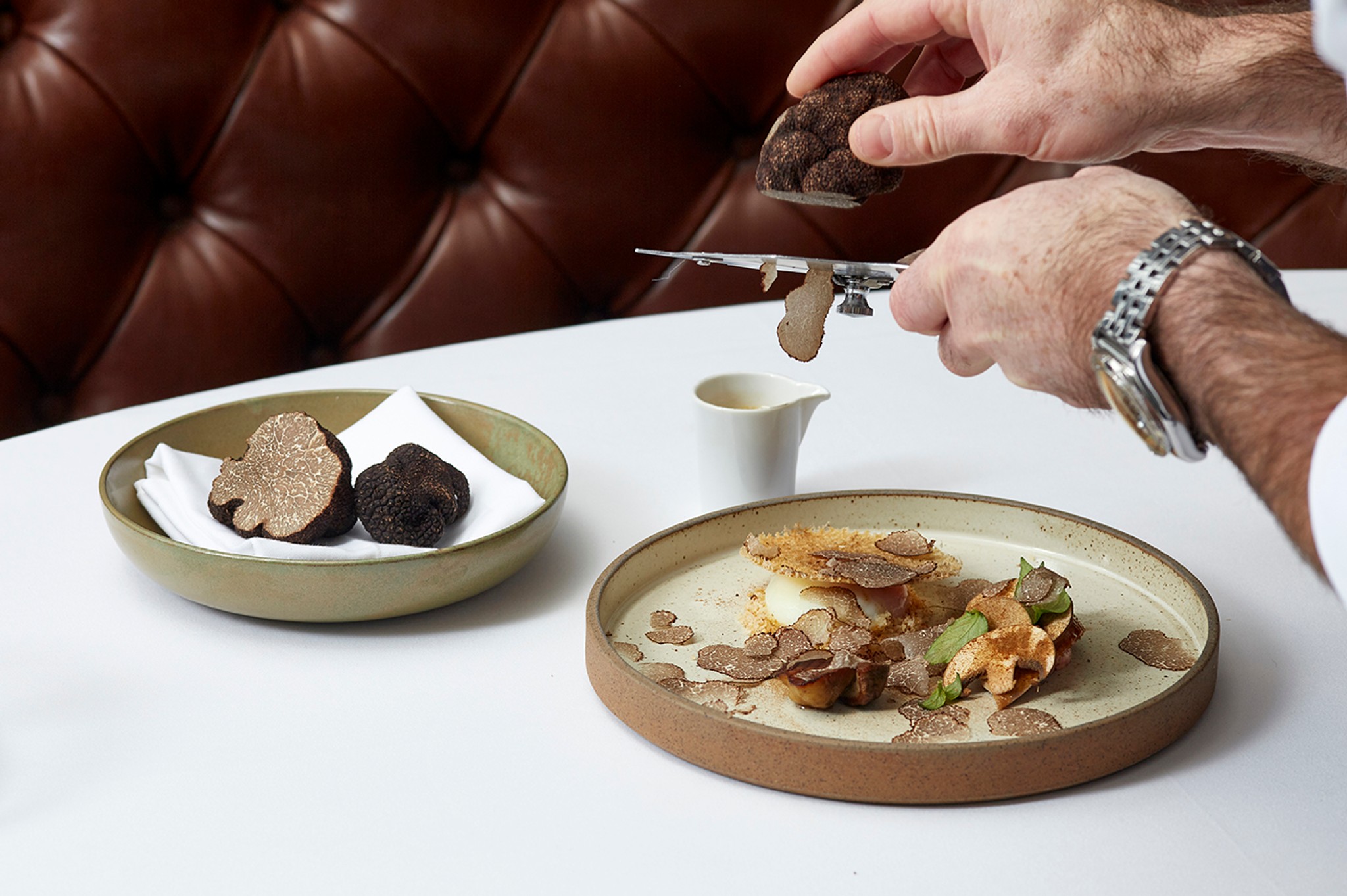 Hand grating truffle over a slow-cooked egg dish at Marcus Belgravia
