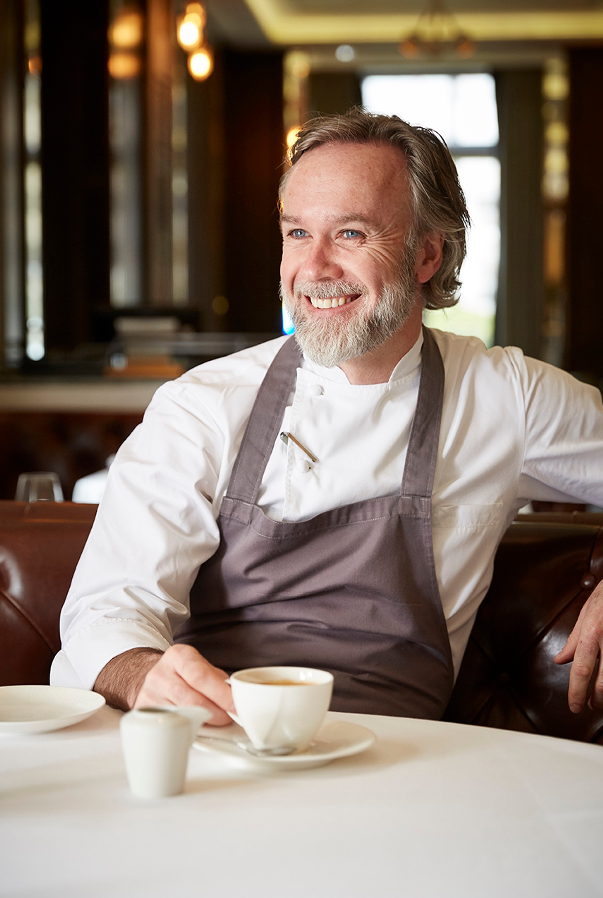 Marcus Wareing sitting at a table in Marcus Belgravia restaurant, Michelin-starred restaurant in London