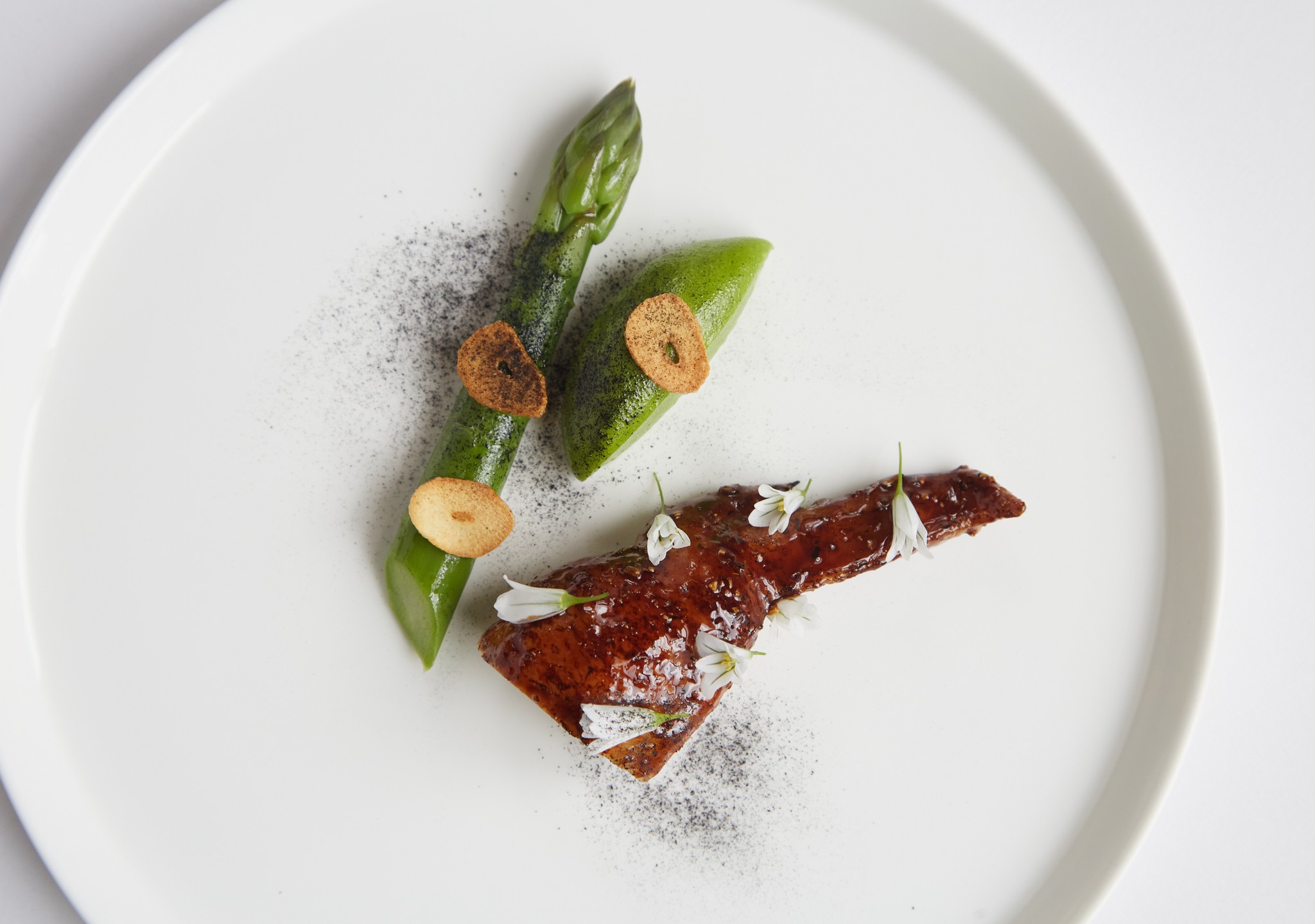 Overhead shot of Cumbrian chicken wing with asparagus and wild garlic from Marcus Restaurant