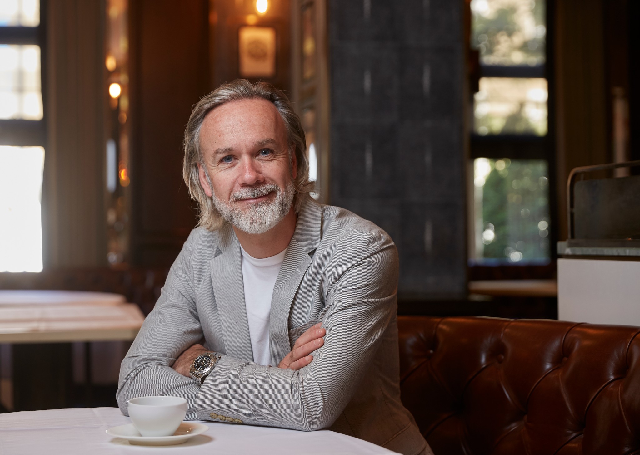 Marcus Wareing sitting in Marcus Belgravia with a coffee up in front of him