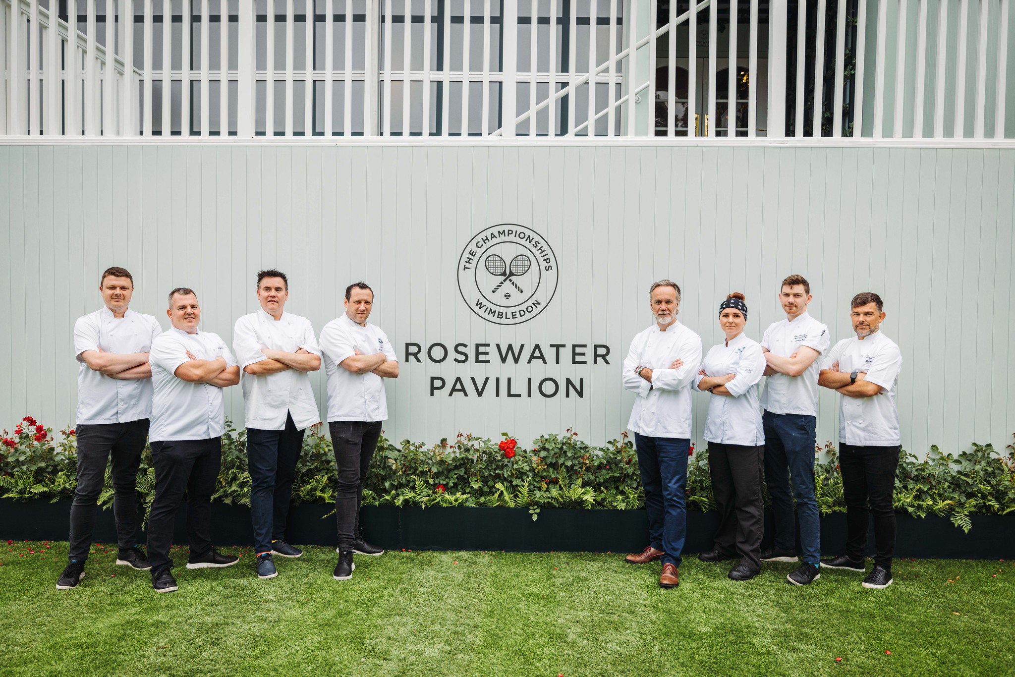 Eight chefs standing in front of Rosewater Pavilion at 2023 Wimbledon Championships 