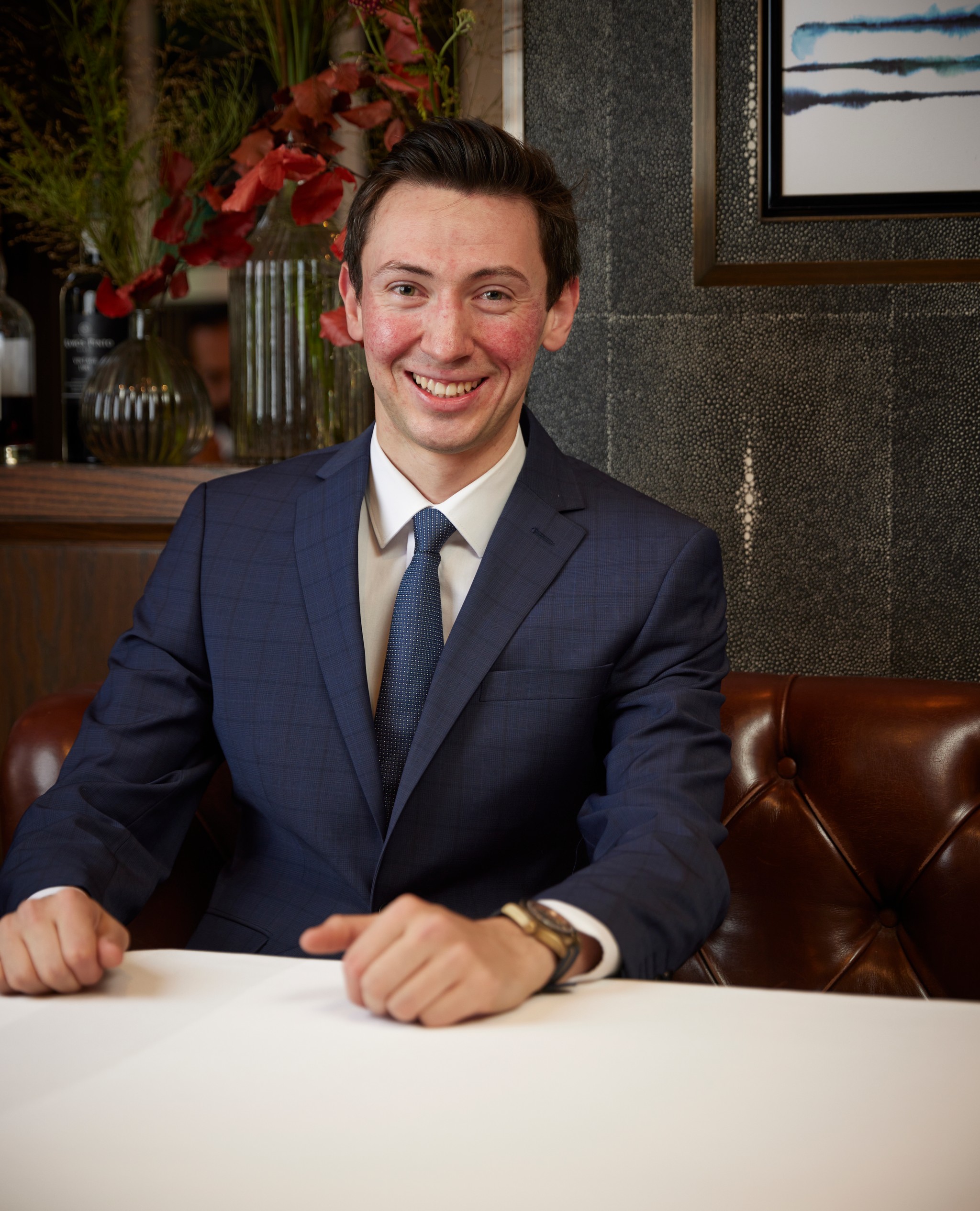 Mladen Mladenov sitting in a banquette at Marcus Belgravia with his hand on the table 