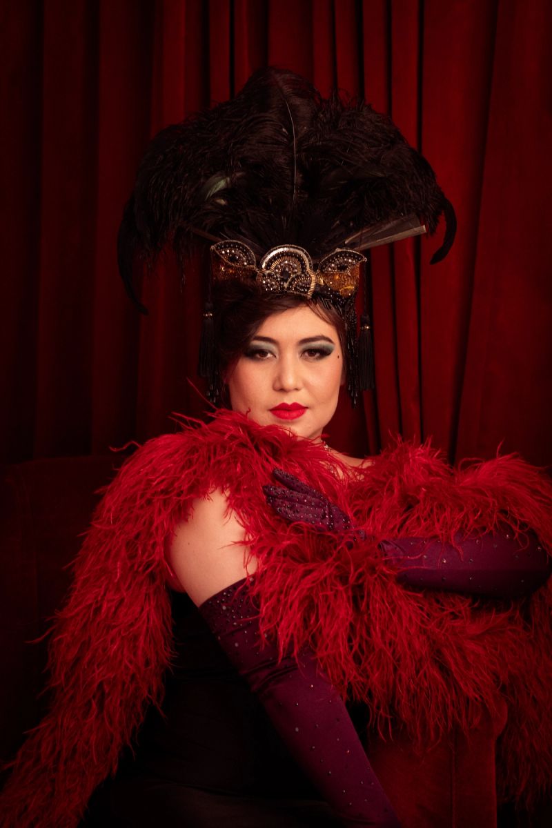 Evelyn in a long sleeved, maroon satin robe with gold lining and gold decorative harness. Photography by Captured By Corinne