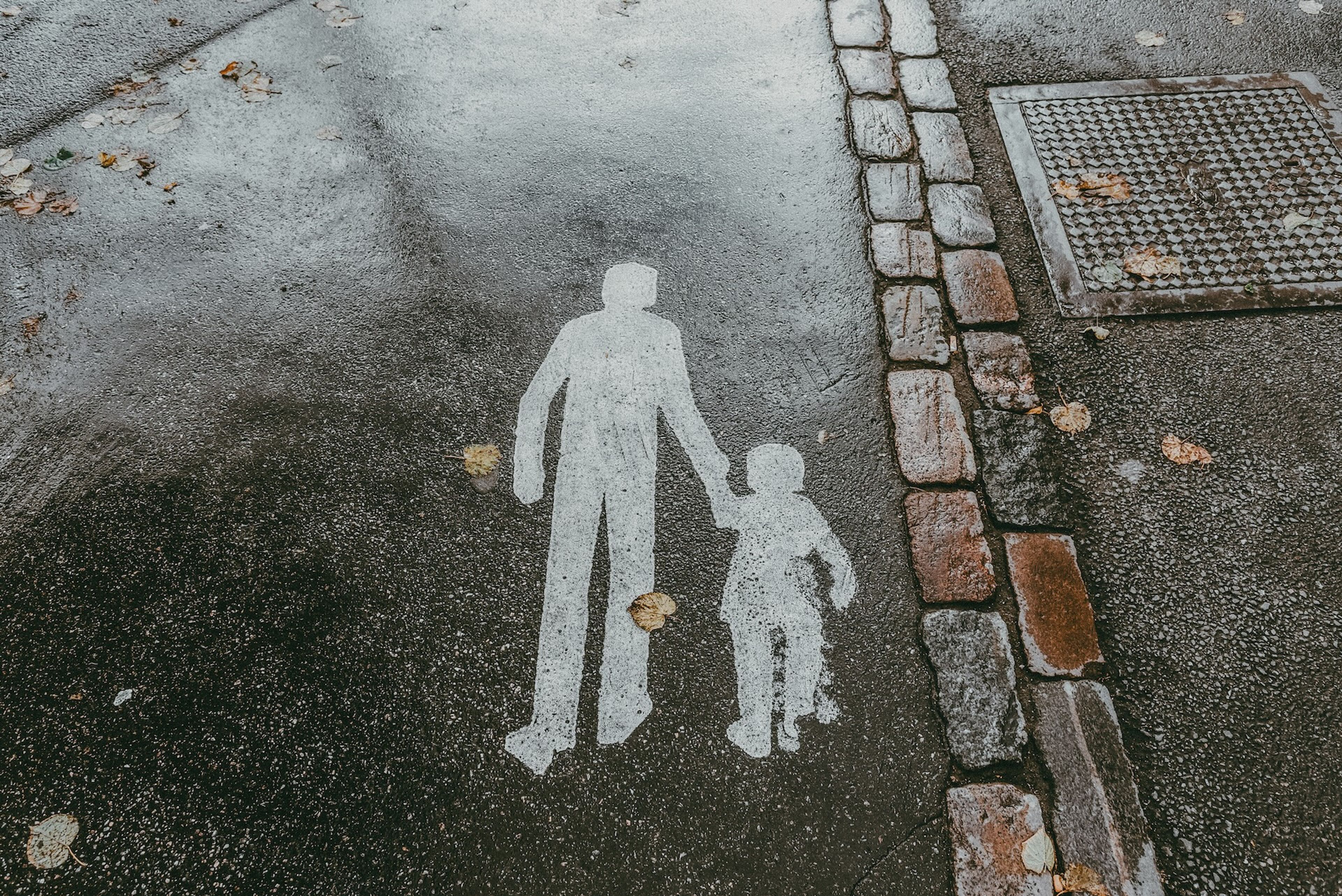 Signage on the ground illustrating eldery and kid holding hands