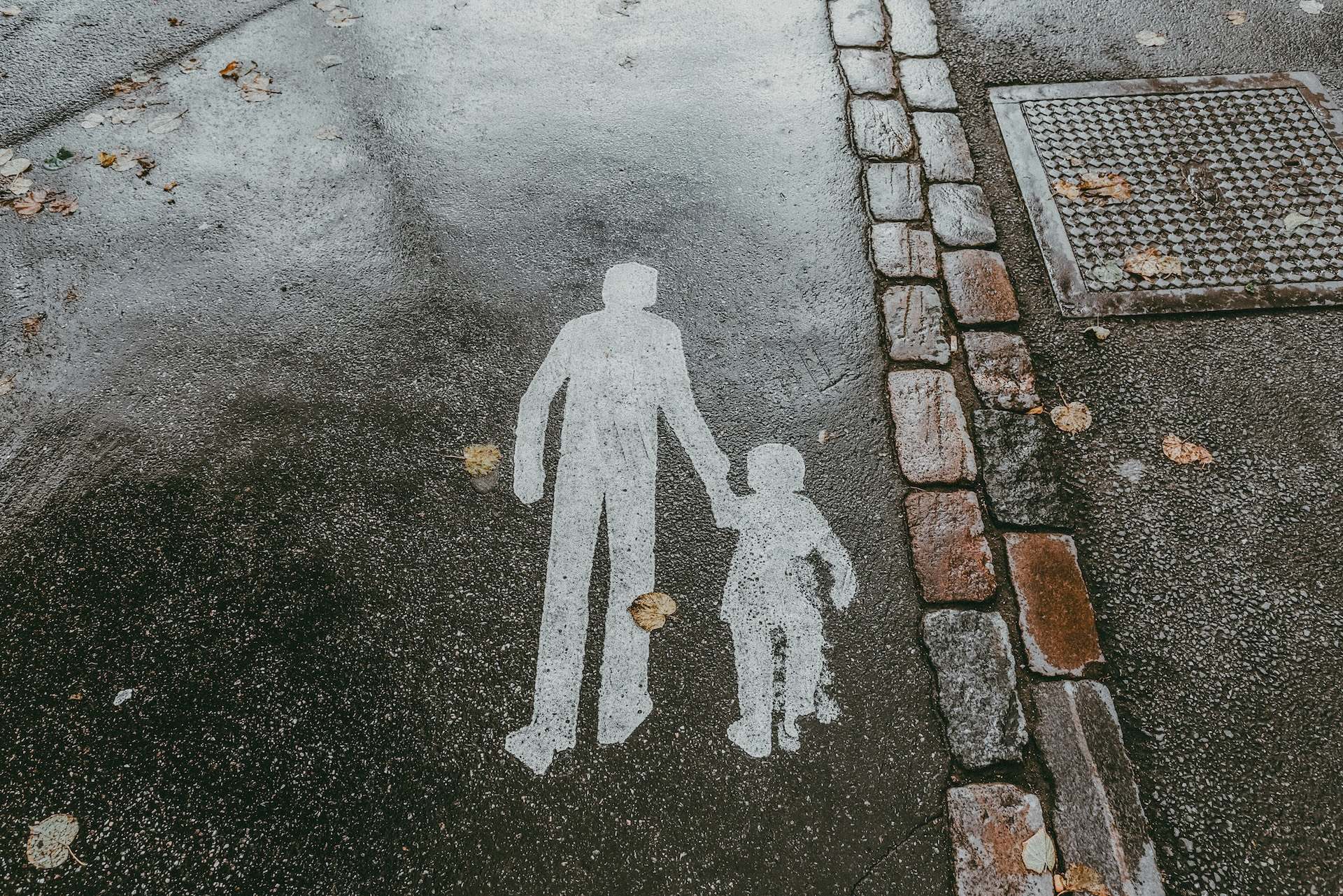 Signage on the ground illustrating eldery and kid holding hands