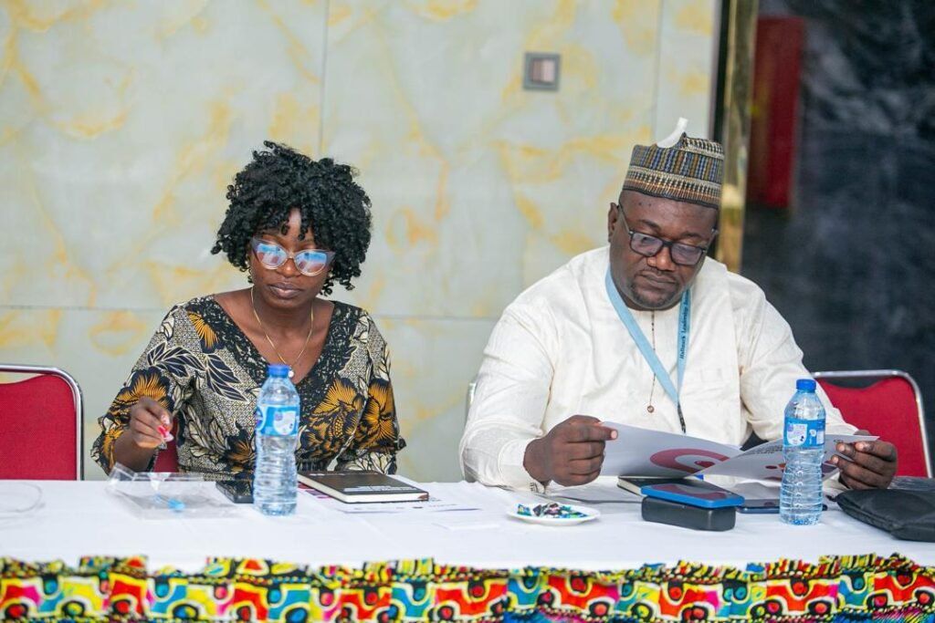 HALI team members reviewing programme materials during a meeting.