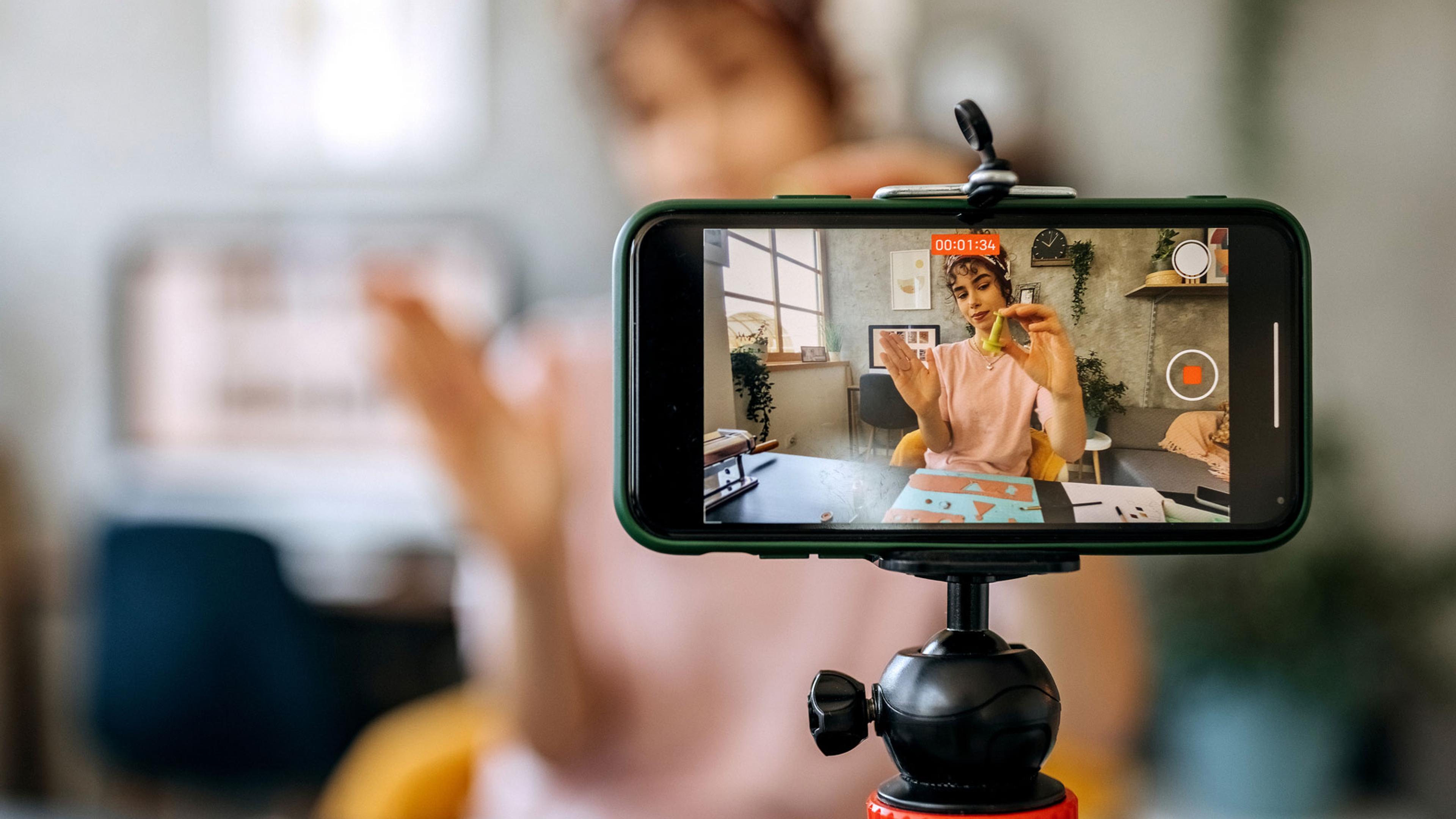 Bilde av en person som filmer med mobilen