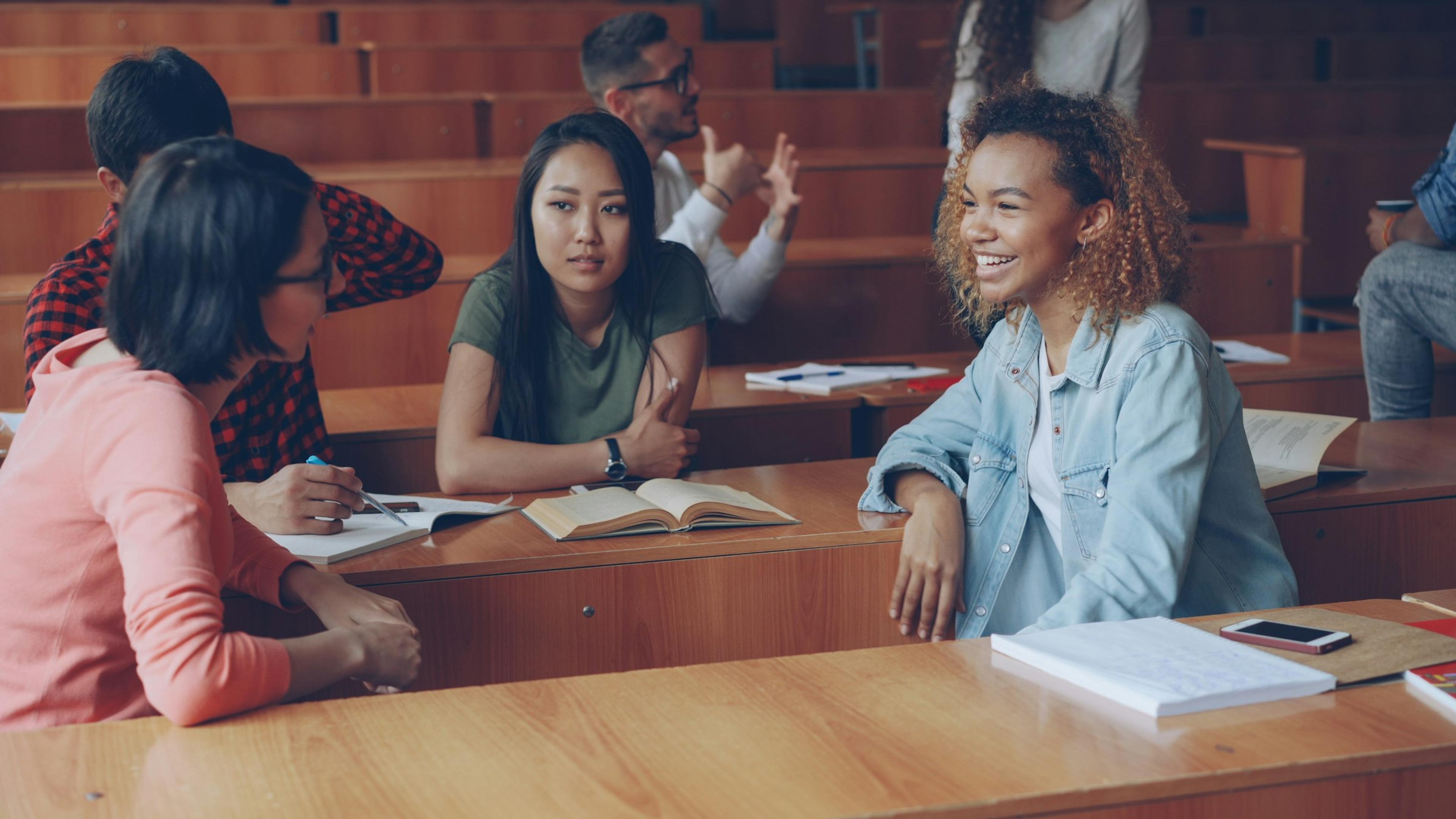 Students in conversation in a lecture hall