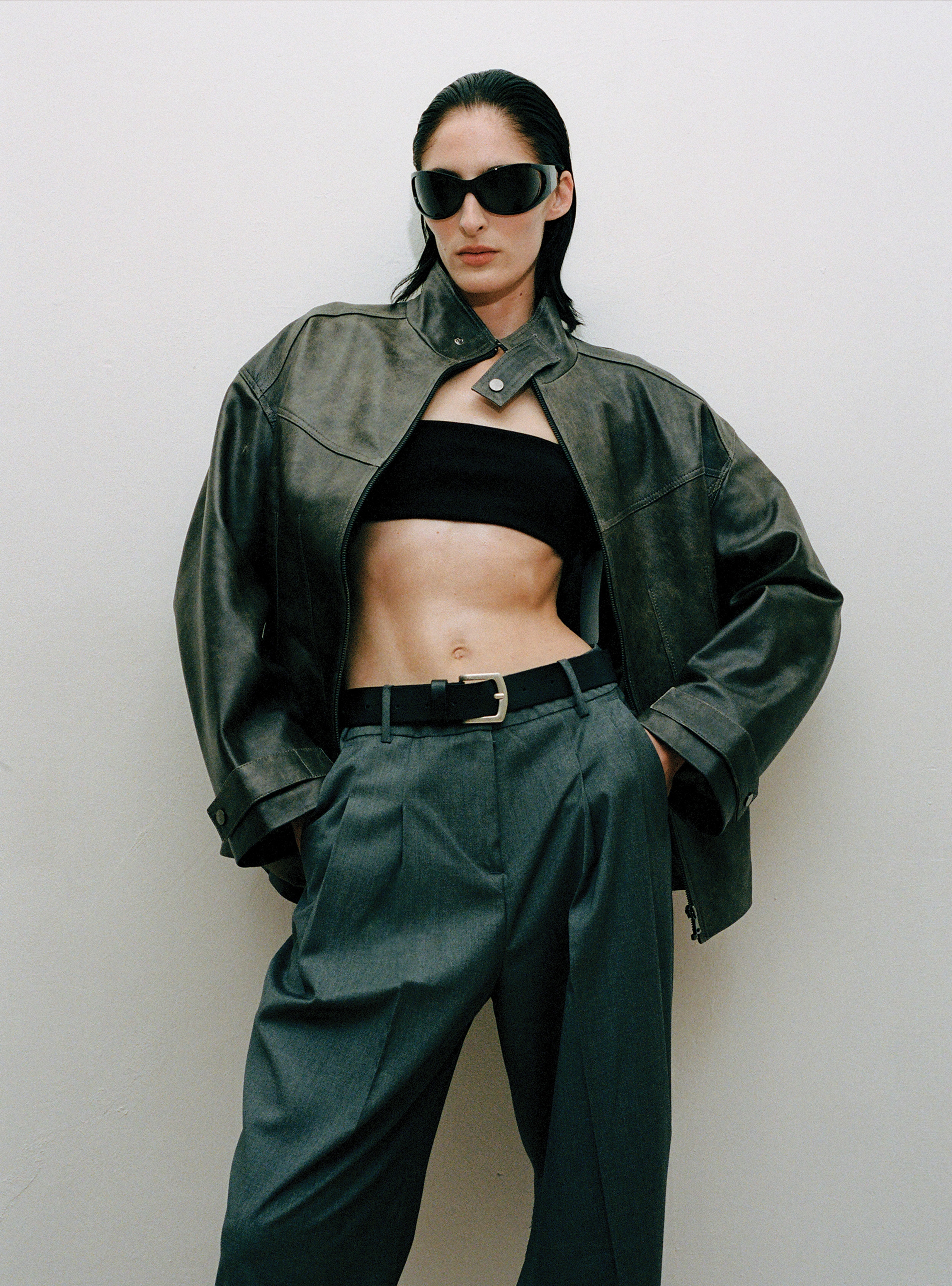 A model standing wearing the Rue Dark Marble leather jacket