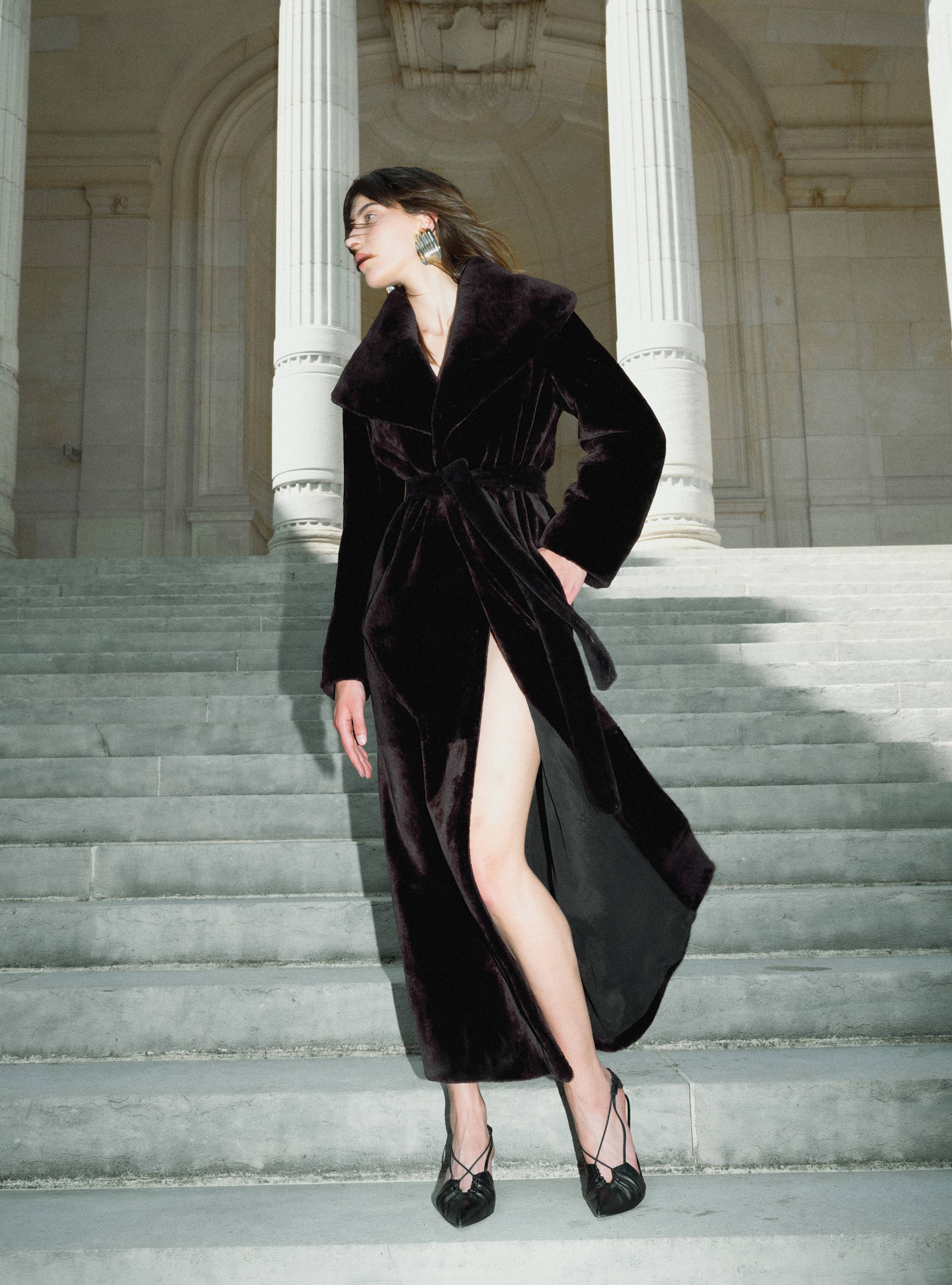 A model wearing the Giovanna Chocolate Fondant long shearling coat