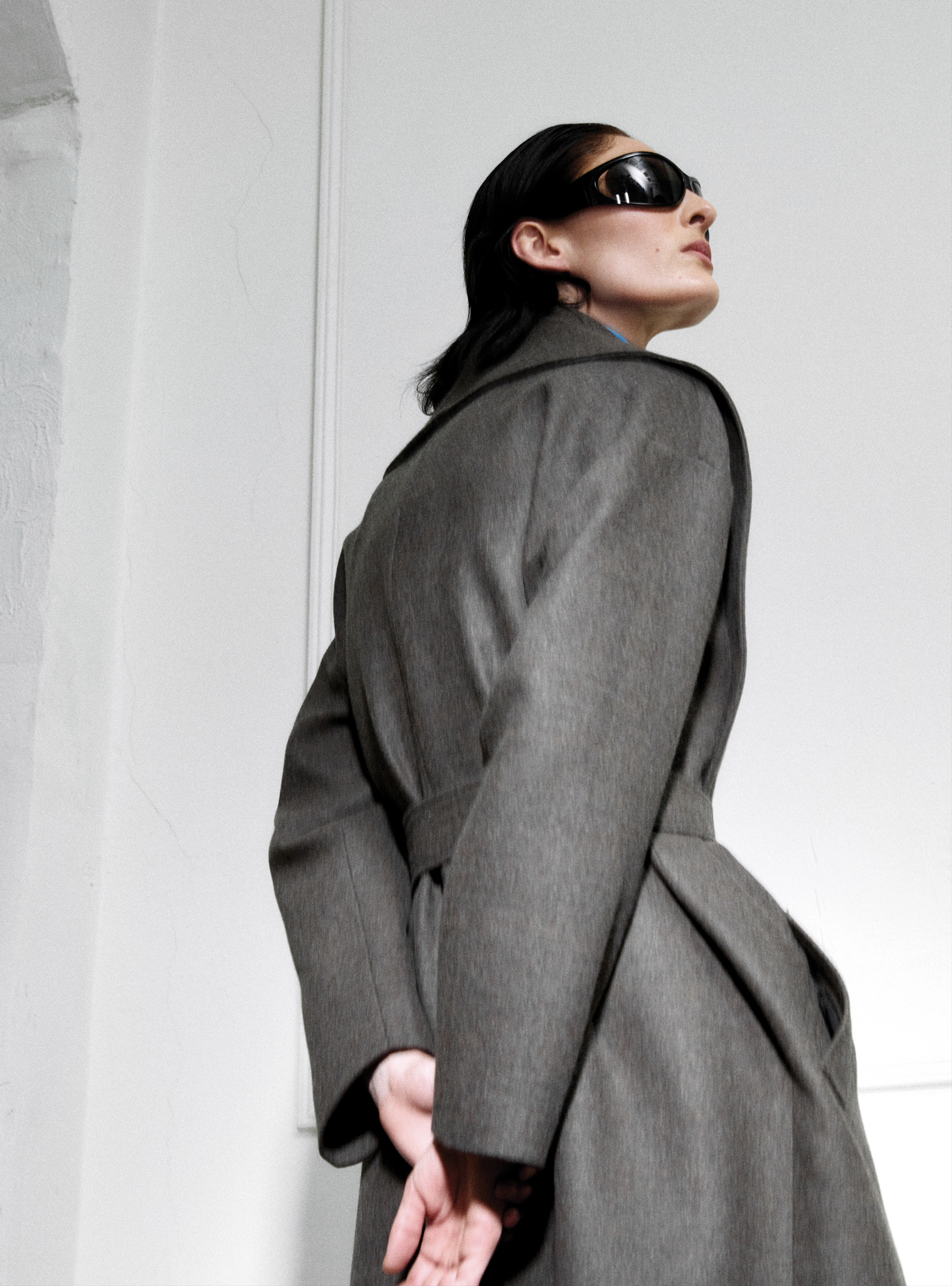 A model looking to the side wearing the Lucee Thunder long blanket coat