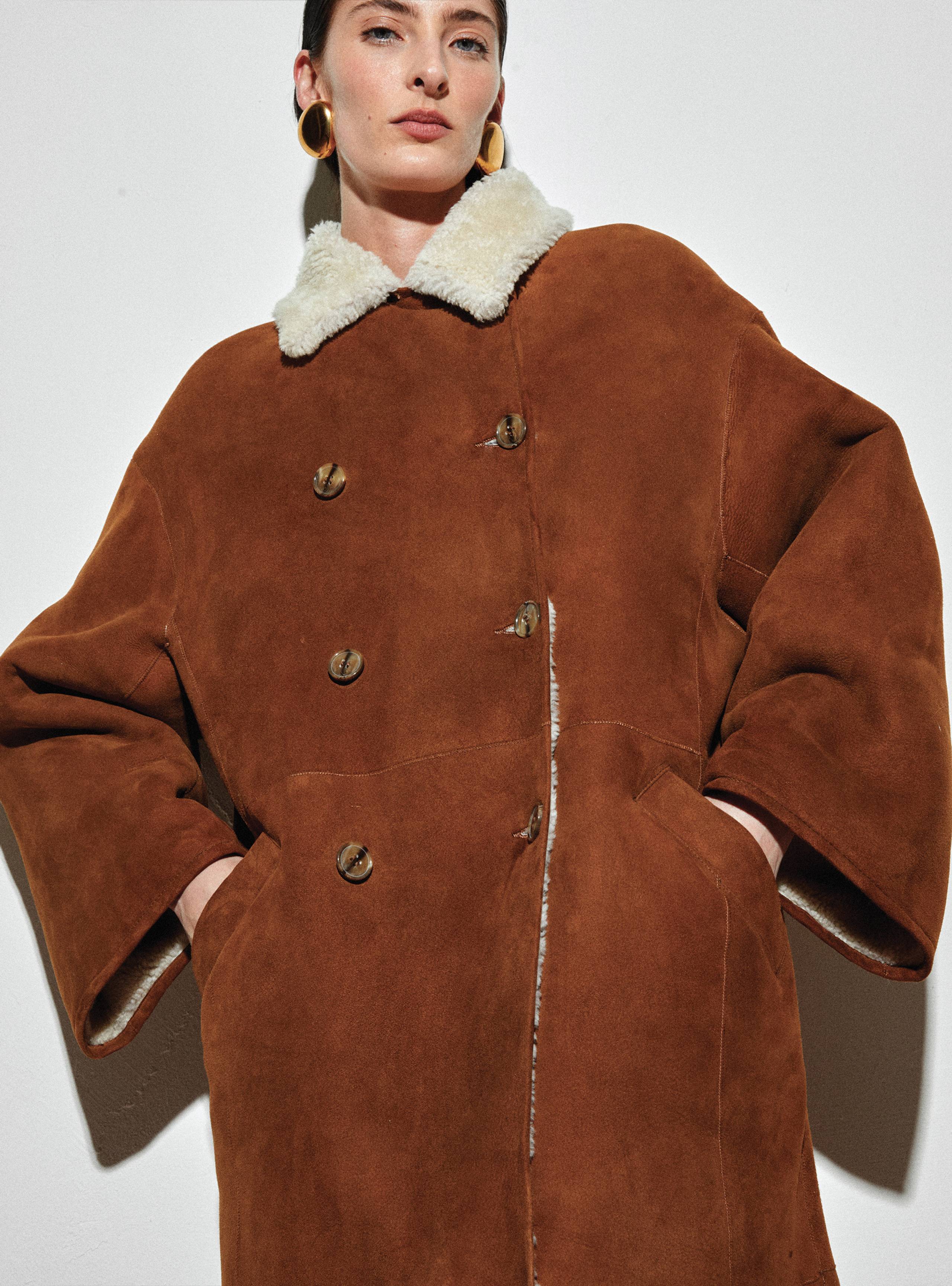 A model wearing the Noisette Double Brested shearling coat